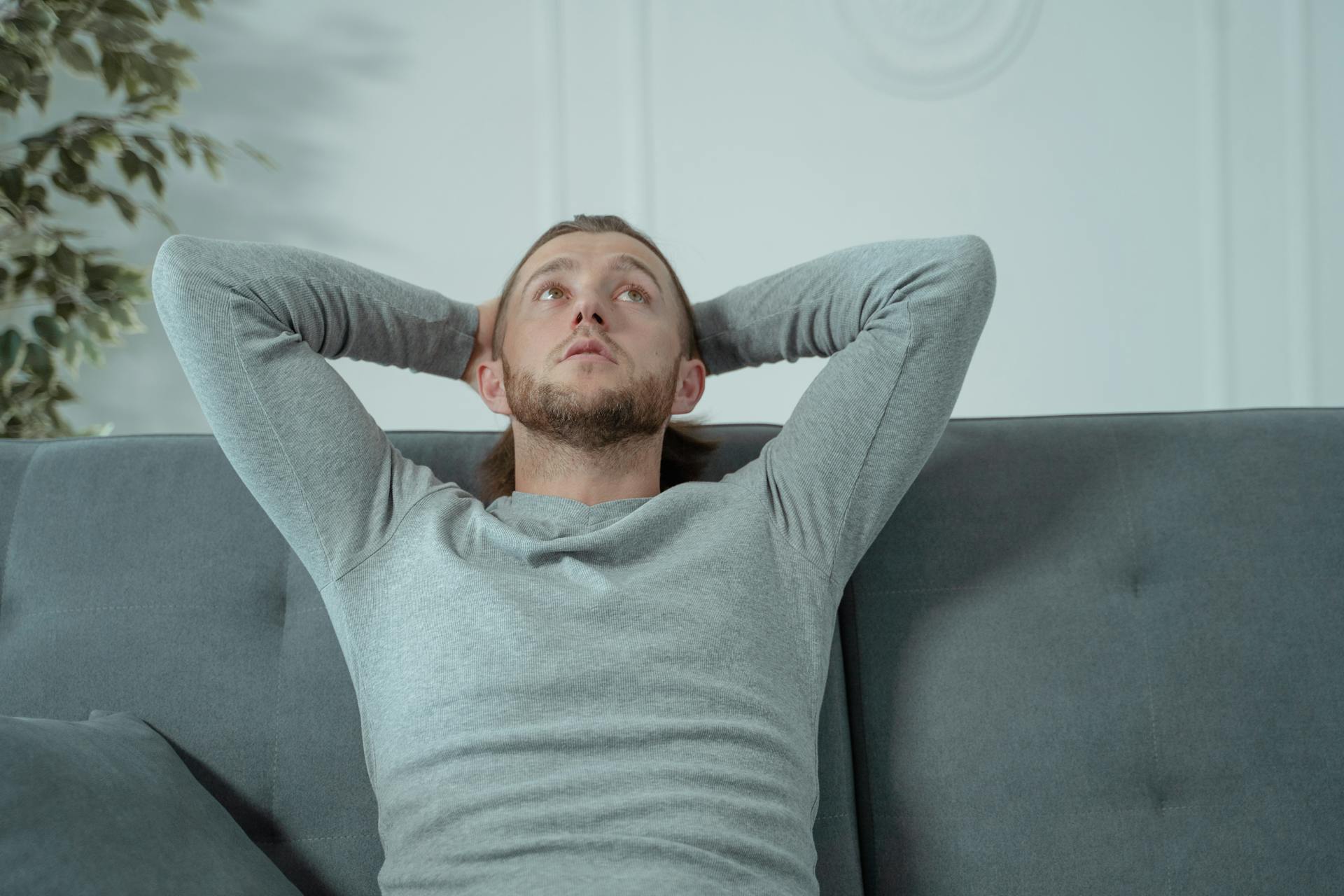 A man leaning back on a sofa | Source: Pexels