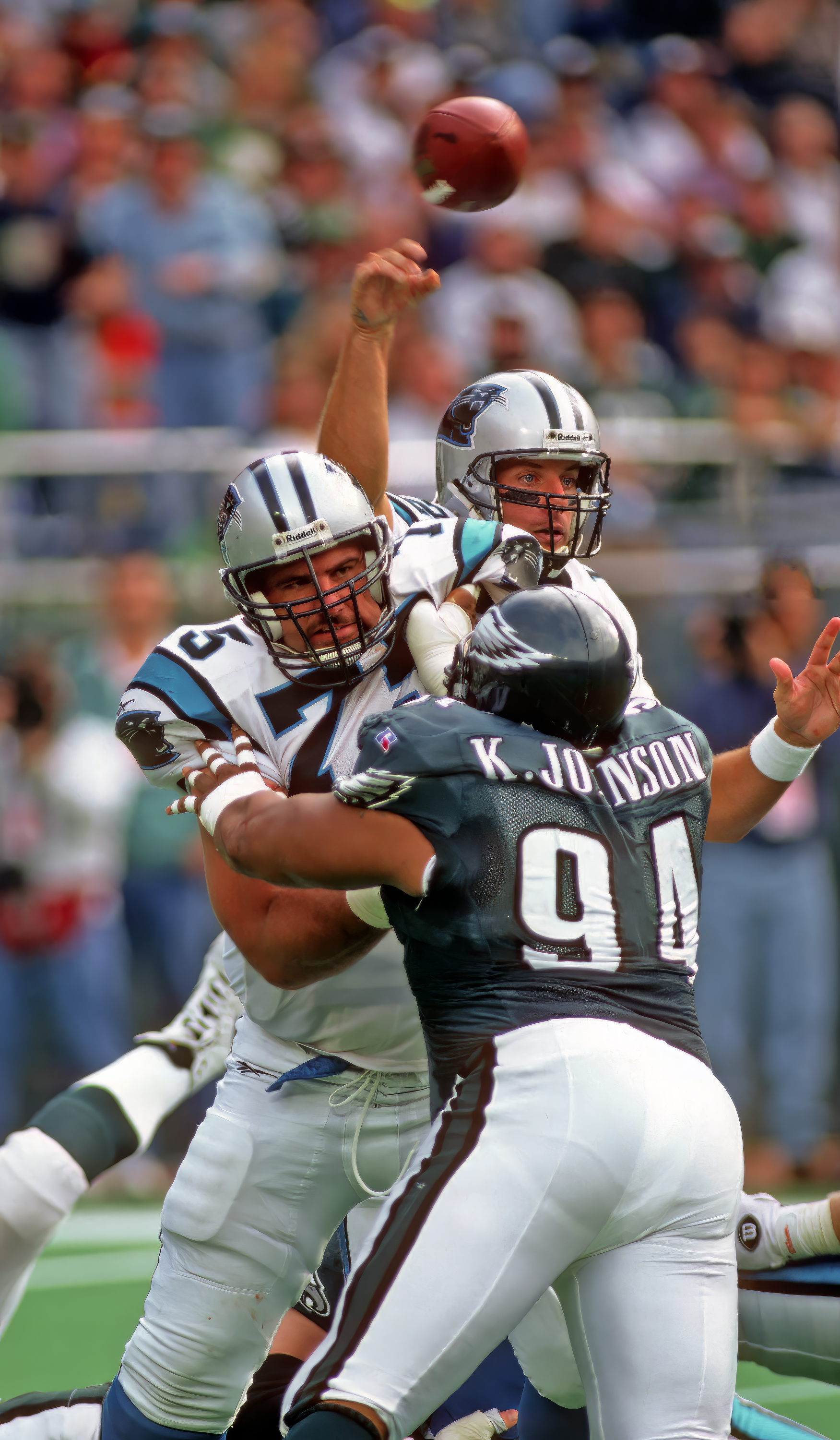 Guard Greg Skrepenak #75 of the Carolina Panthers blocks defensive lineman Kevin Johnson #94 of the Philadelphia Eagles as quarterback Kerry Collins of the Panthers passes during a game at Veterans Stadium in Philadelphia, Pennsylvania  on October 27, 1996. | Source: Getty Images