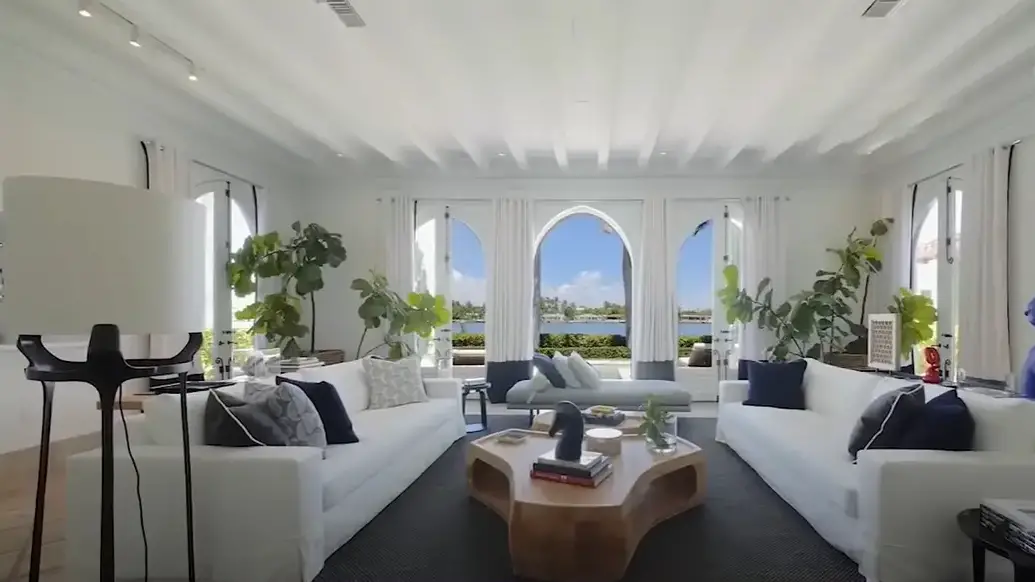 An image showing Cher's former estate's white-themed living area in Miami Beach, Florida | Source: YouTube/ALLABOUT