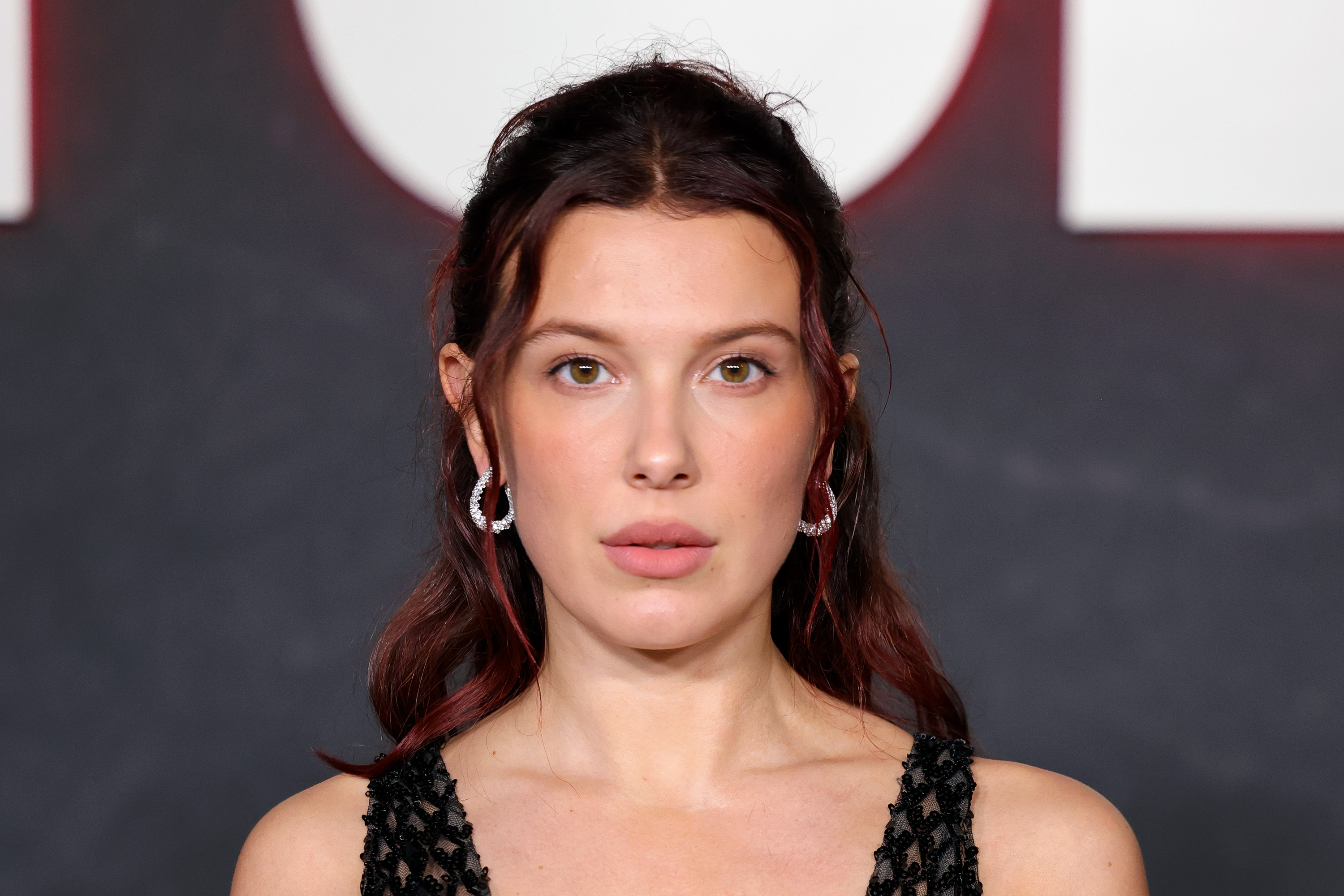 Millie Bobby Brown attends Netflix's "Stranger Things" FYC event in Los Angeles on Nov. 8, 2025. She later chose a pale blue custom gown for the "Enola Holmes 3" world premiere, giving her red carpet look a different style. | Source: Getty Images