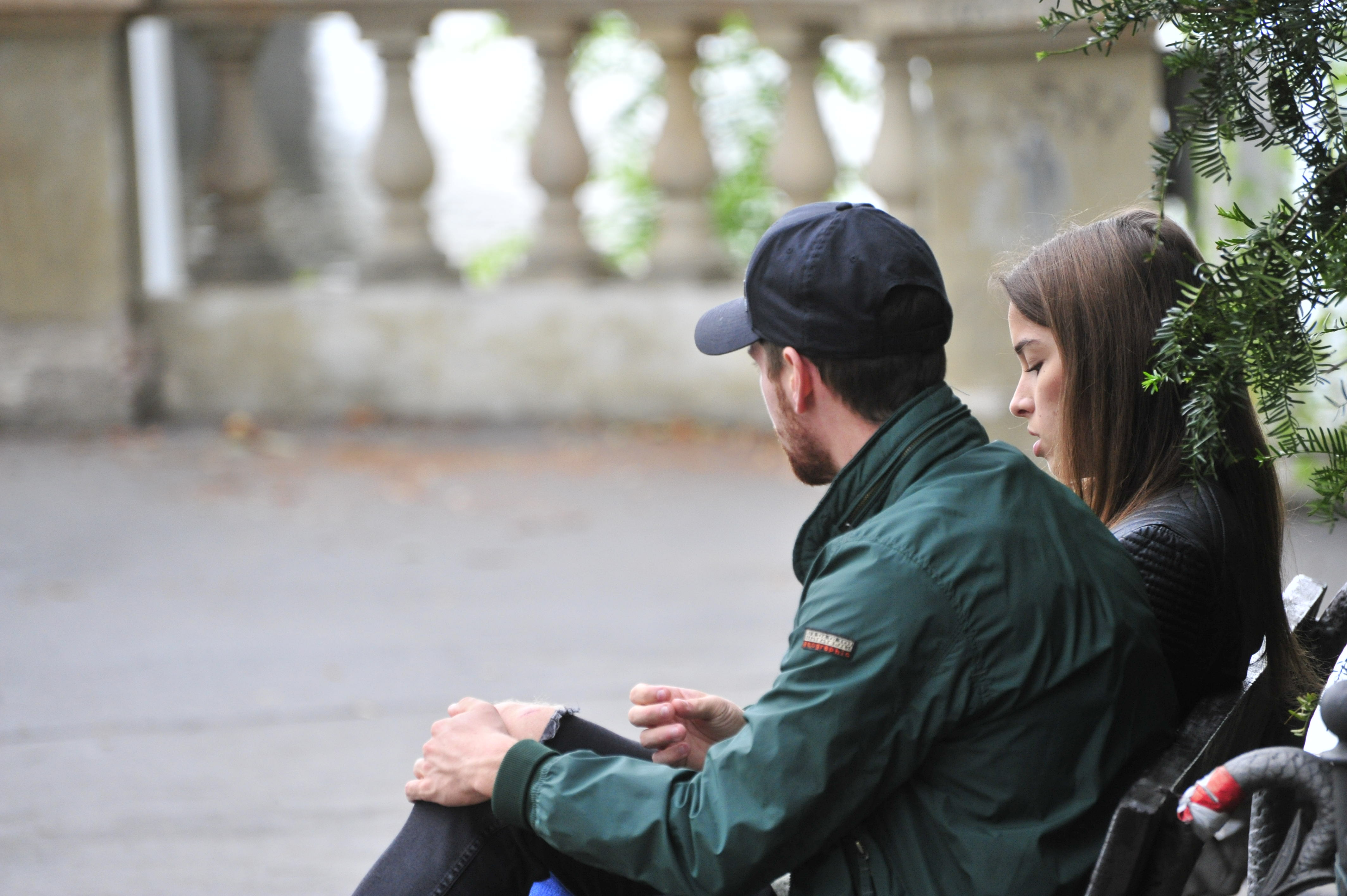 A couple sitting on a bench | Source: Shutterstock