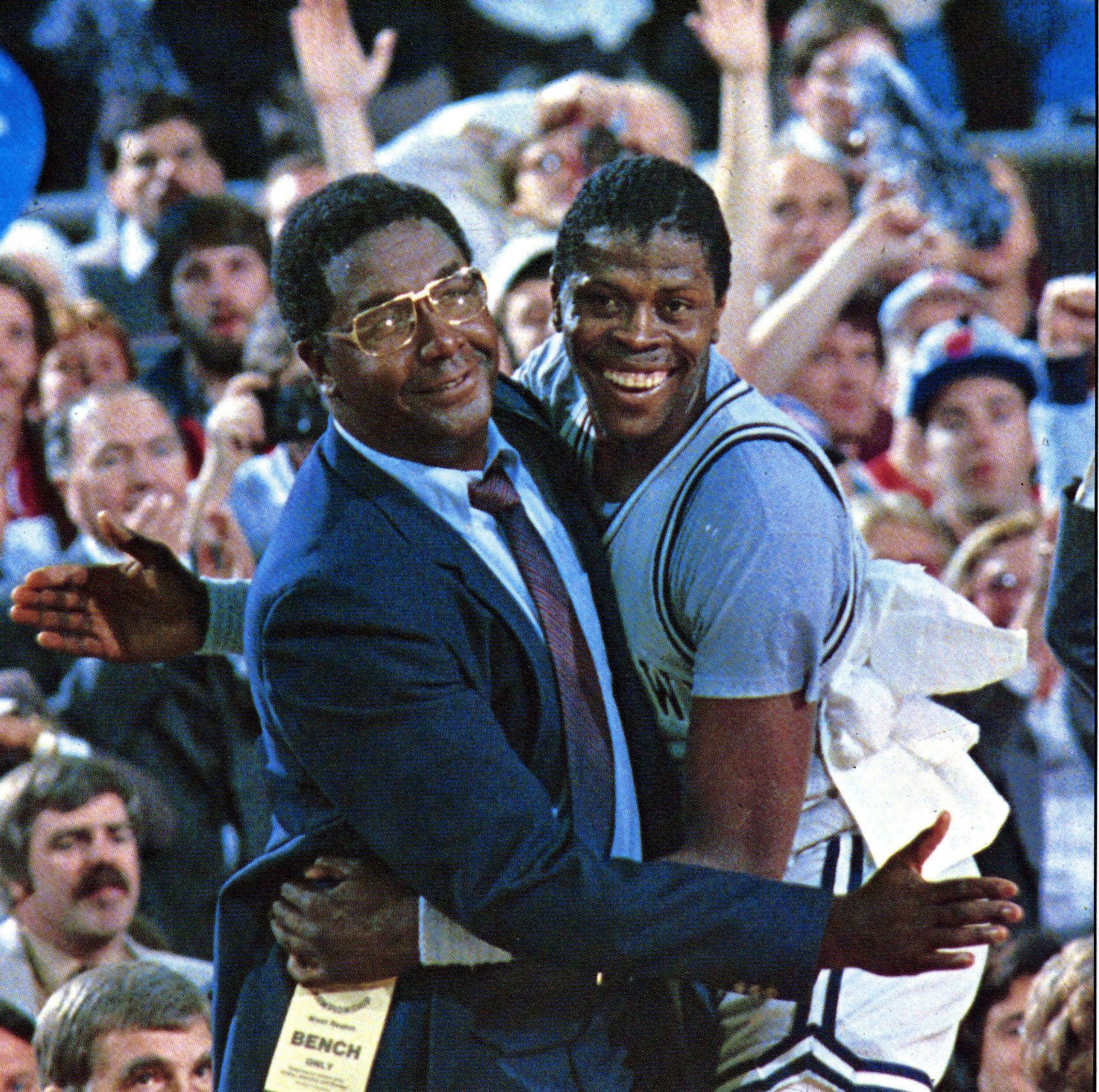 Patrick Ewing and late John Thompson pose for a photo during a game at McDonough Arena in Washington, D.C. | Photo: Getty Images.
