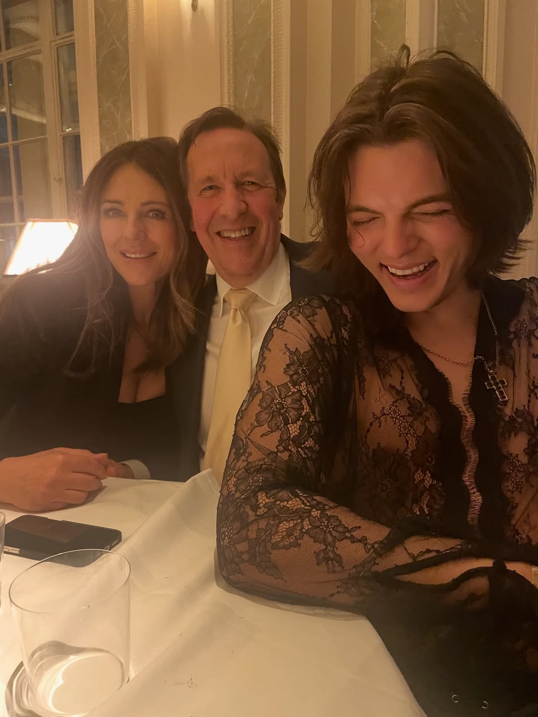 Elizabeth Hurley, Percy Gibson, and Damian Hurley pose for a photo on 15 April 2026. | Source: Instagram/joancollinsdbe