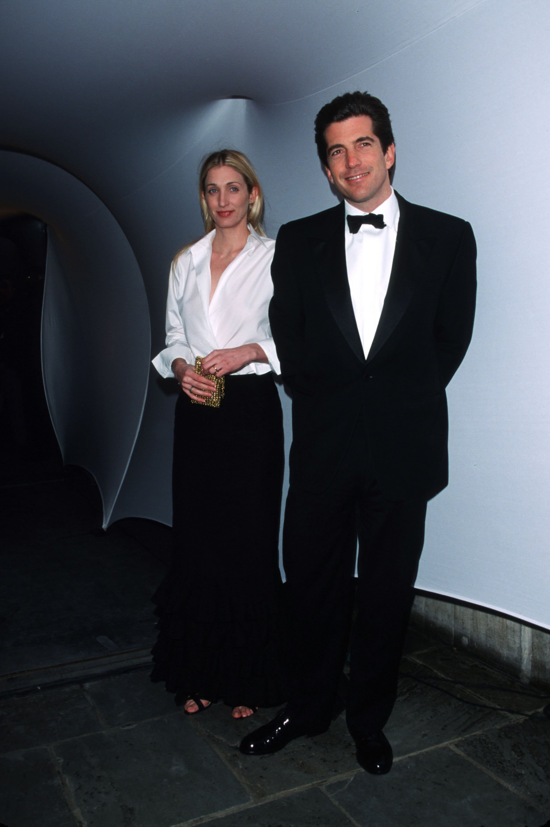 John F. Kennedy Jr. with Carolyn Bessette-Kennedy pictured wearing coordinating black and white outfits in 1995. / Source: Getty Images
