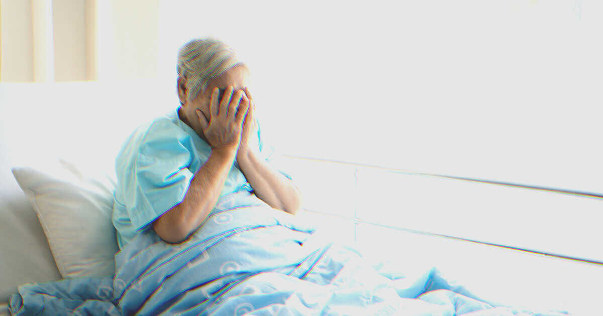 Woman crying in a hospital bed | Source: Shutterstock