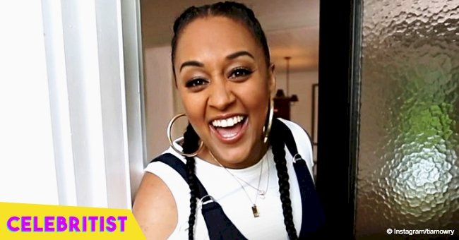 Tia Mowry's daughter strikes a cute pose while wearing pink strawberry print outfit & matching hat