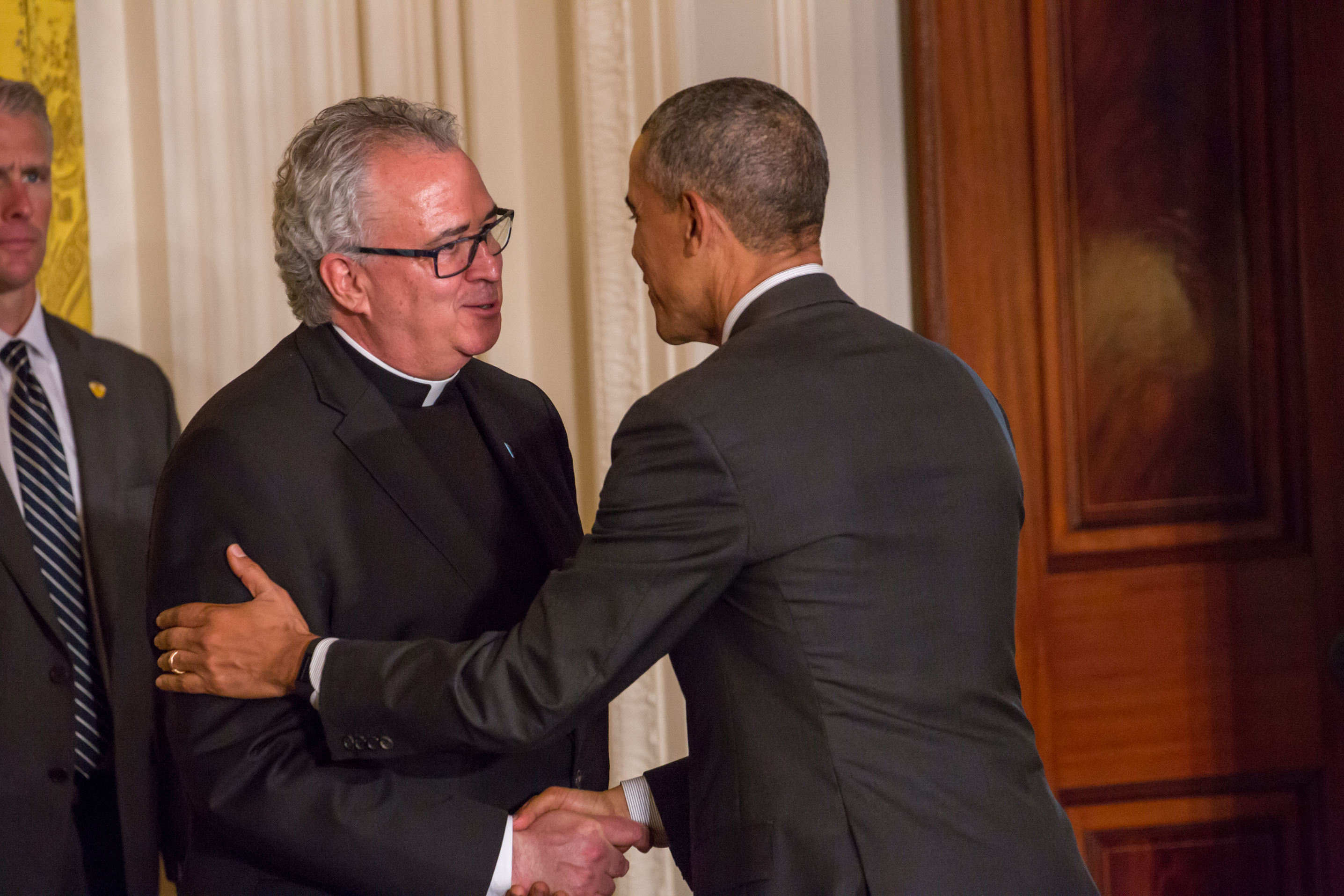 Rev. Peter M. Donohue, Villanova University President, and former US President Barack Obama speak on January 19, 2016 | Source: Getty Images