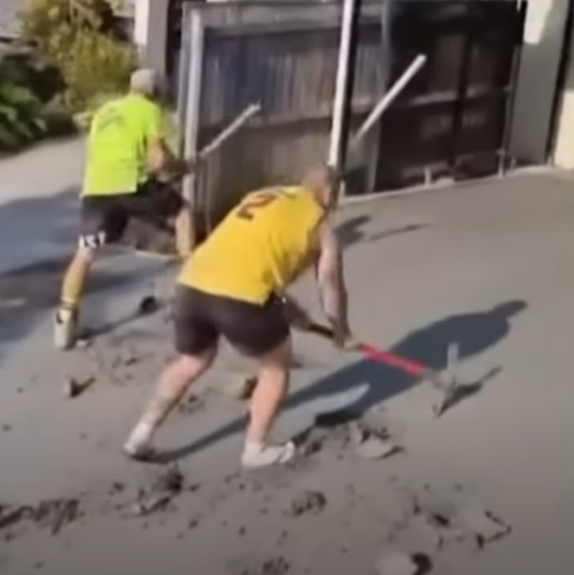 Two concreters smashing a concrete driveway, from a video dated January 8, 2024 | Source: YouTube/7NEWS Australia