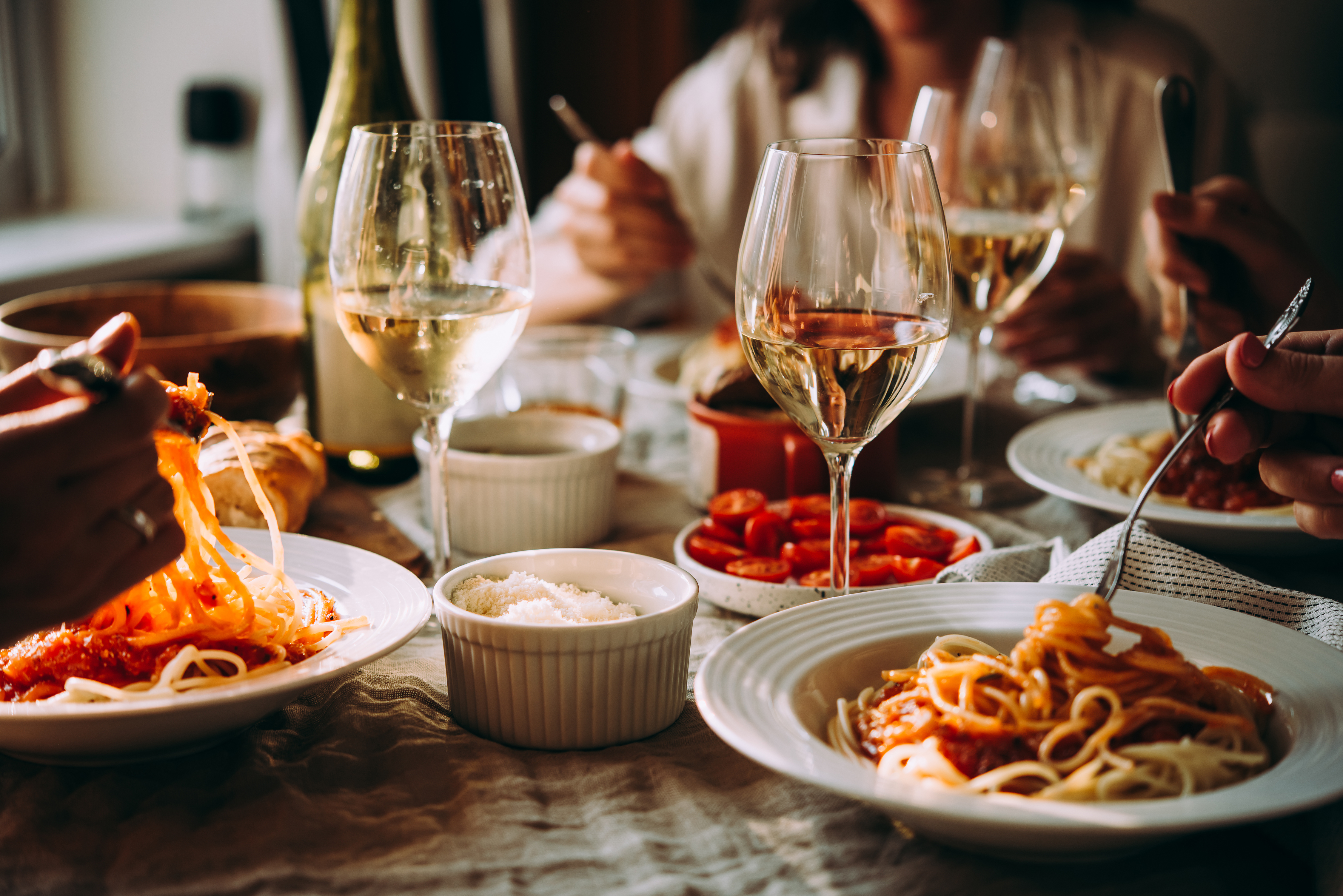 Friends having a pasta dinner | Source: Shutterstock
