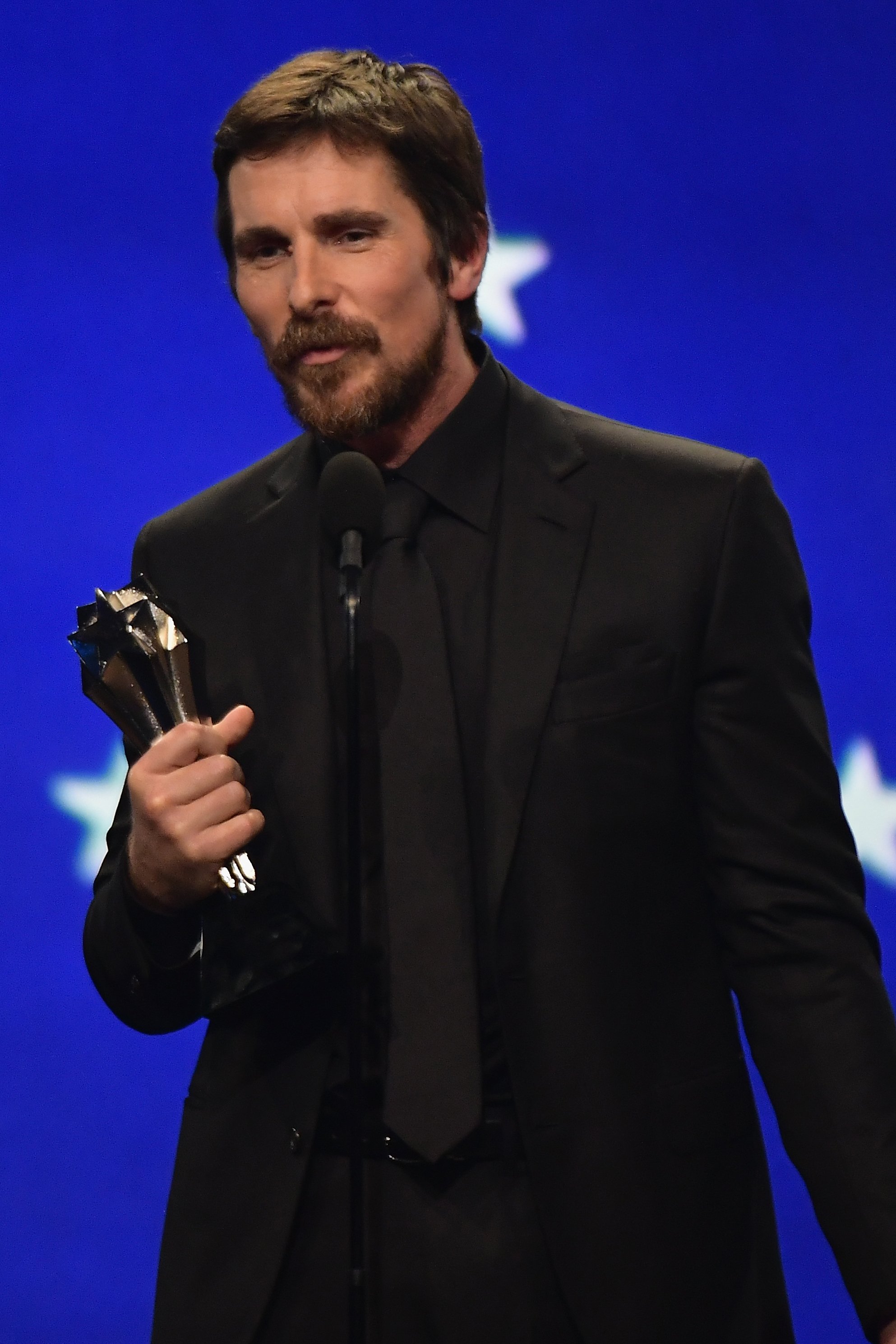 Christian Bale accepts Best Actor in a Comedy Movie Award for "Vice" during the 24th annual Critics' Choice Awards at Barker Hangar on January 13, 2019 in Santa Monica, California. | Source: Getty Images