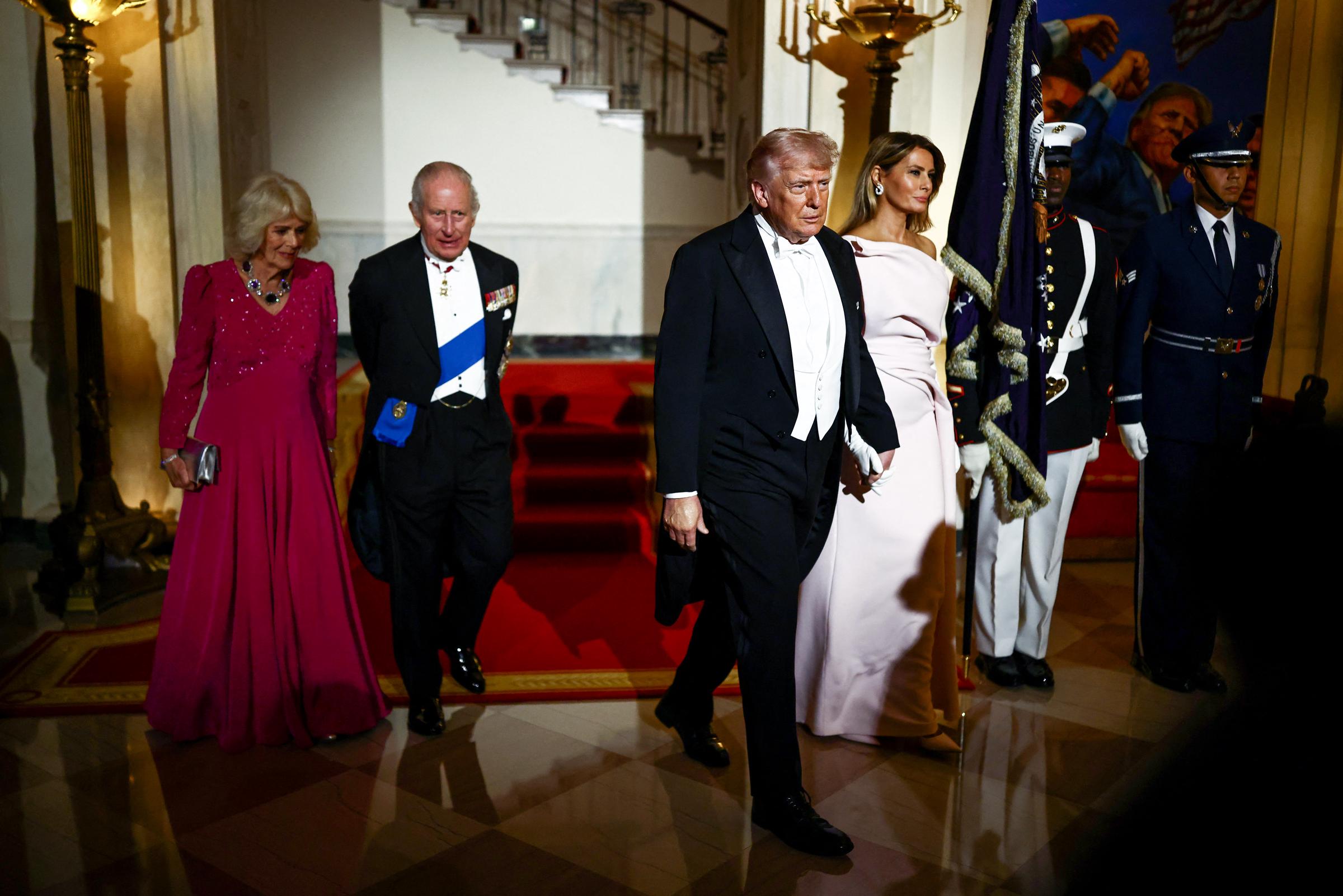 Donald Trump, Melania Trump, King Charles III, and Queen Camilla head over to the hall for a State Dinner in the White House East Room, April 28, 2026. | Source: Getty Images