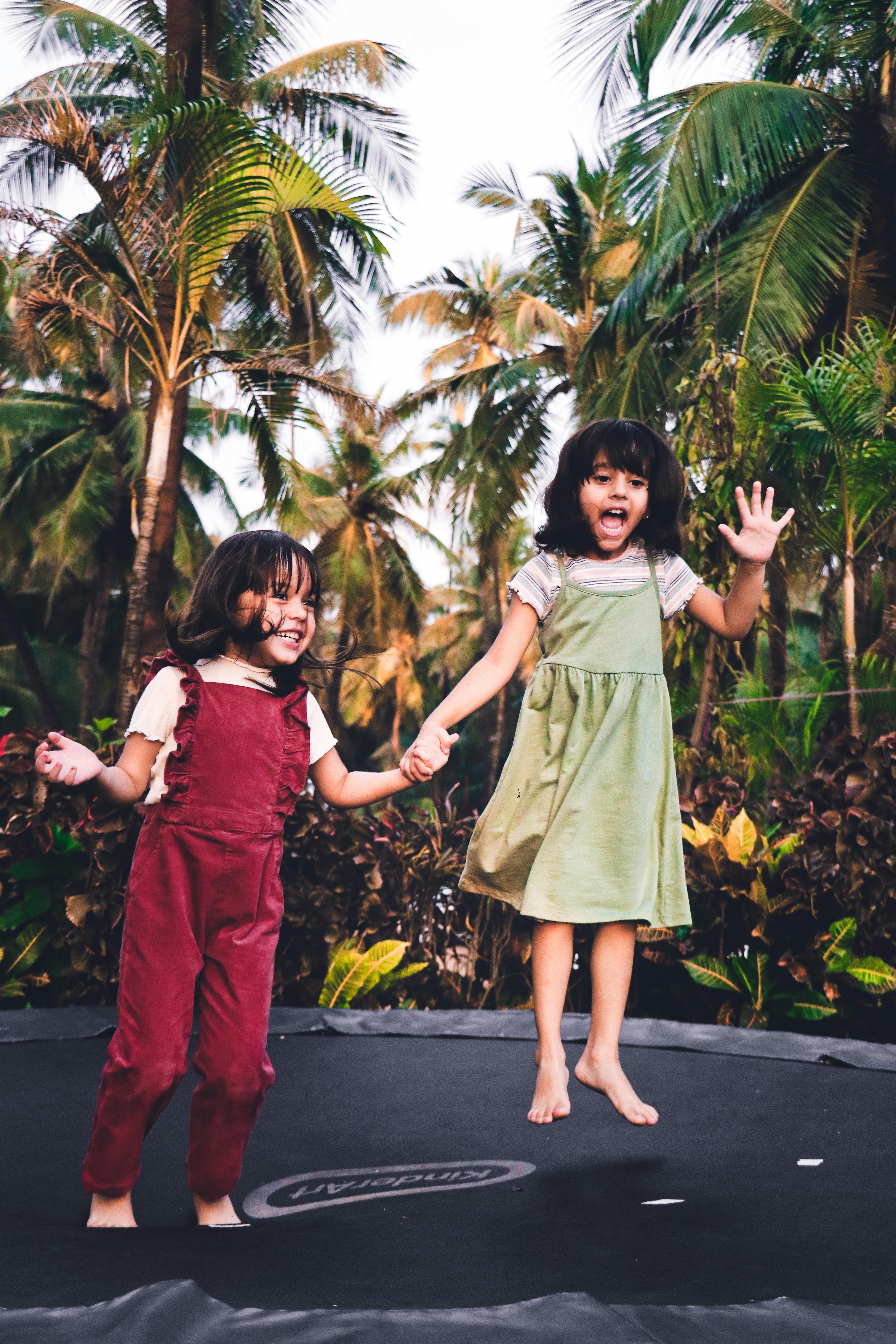 Two little girls on a trampoline | Source: Pexels