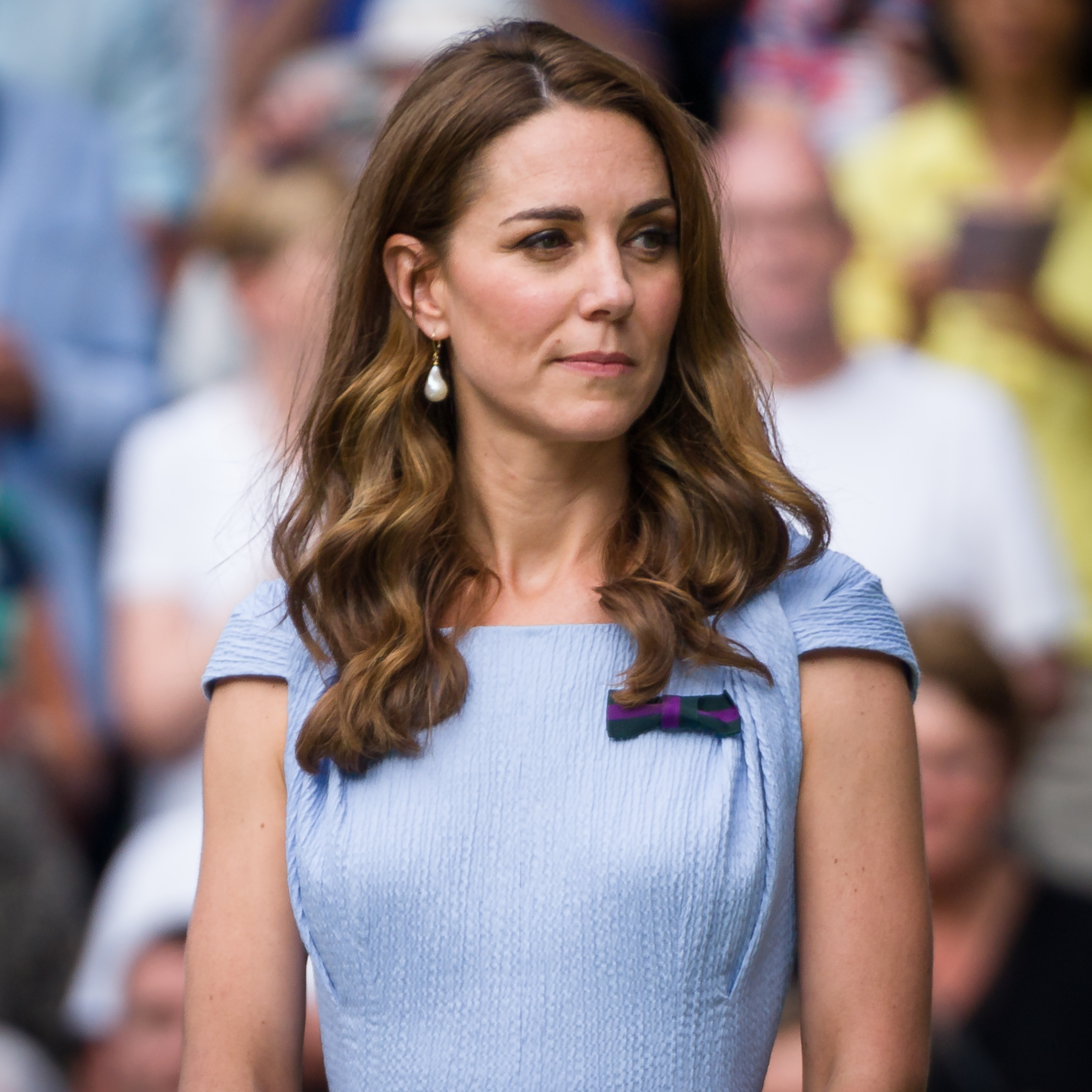 Kate Middleton watches the action with focused attention from the stands at Wimbledon, combining timeless sophistication with her well-known passion for the prestigious tennis tournament.