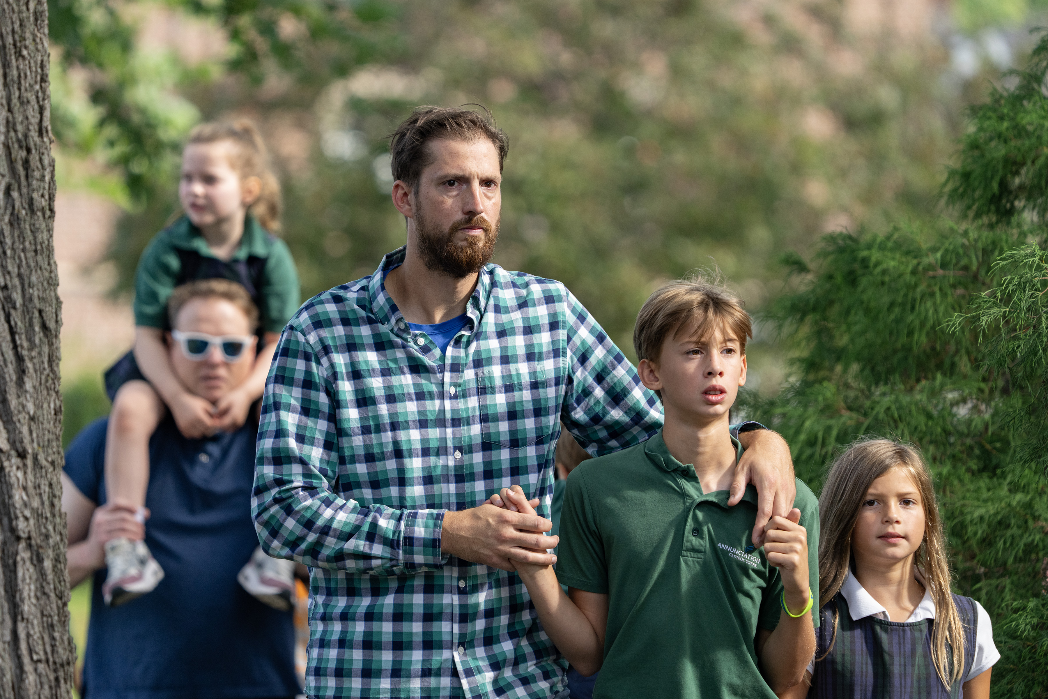 Parents lead their children out of Annunciation Catholic School in Minneapolis after the church shooting on August 27, 2025 | Source: Getty Images