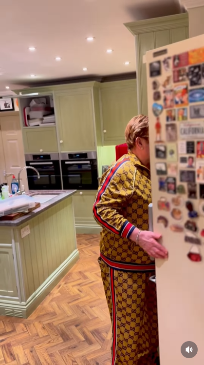 Not even the walk-in freezer offers refuge. John swings open the door, only to be met with the same relentless chorus — proving there's truly no escaping "Step Into Christmas" in this house. | Source: Instagram/eltonjohn
