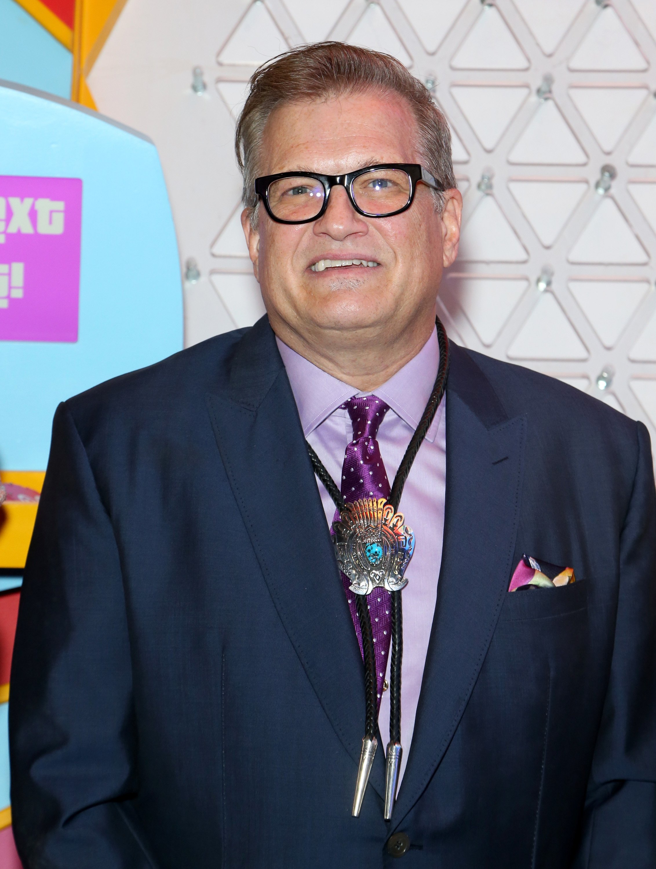Drew Carey stands in front of a Plinko game for the "Price is Right" Slot Machines announcement in Las Vegas, Nevada on October 10, 2018 | Photo: Getty Images