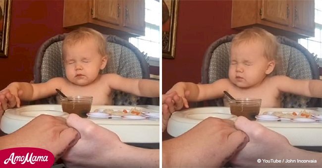 Toddler holds hands and prays with parents at the dinner table, but her serious face goes viral.