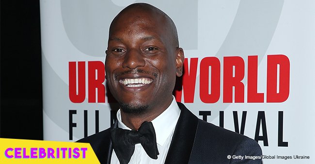 Tyrese Gibson's wife flaunts growing baby bump in navy blue dress 