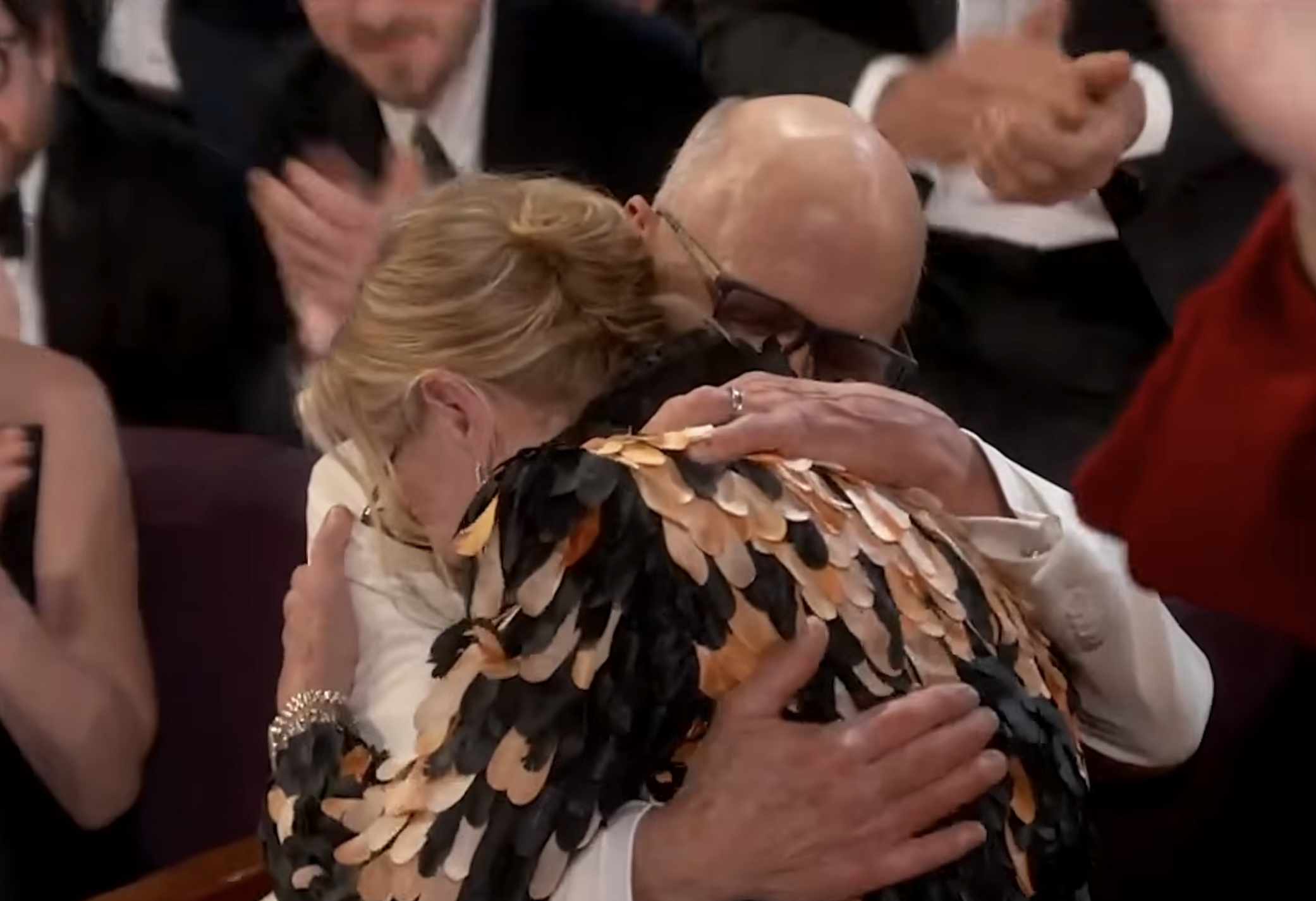 Amy Madigan shares an emotional embrace after hearing her name called | Source: YouTube/ABCNews