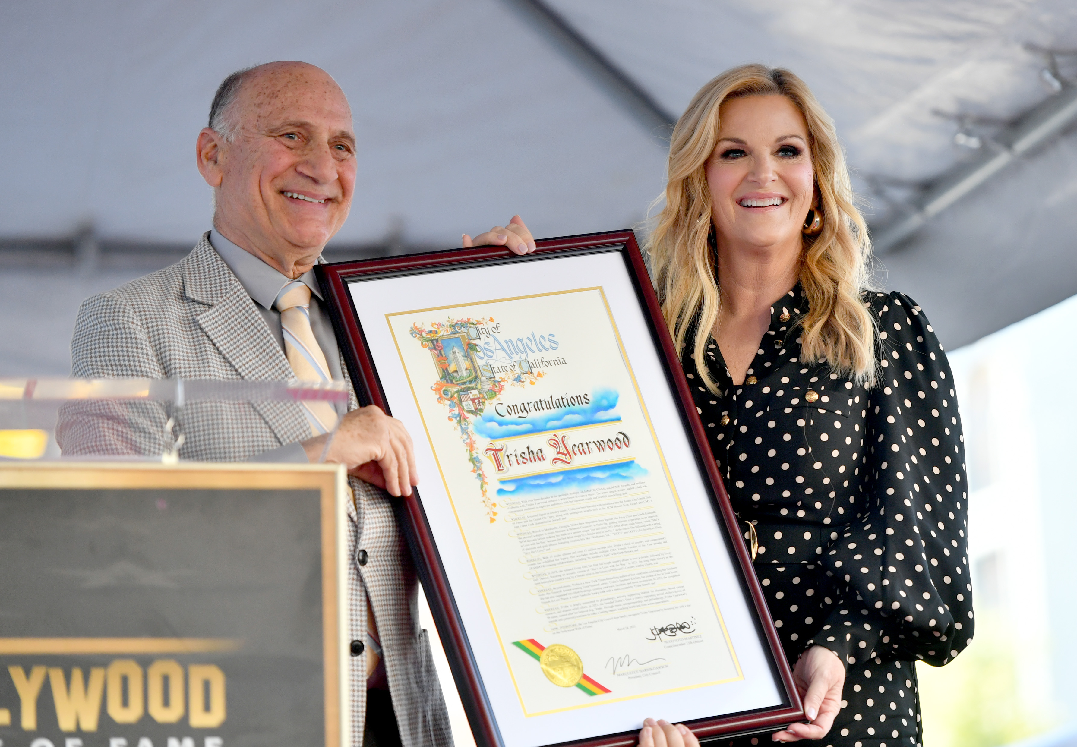 Steven Nissen, President & CEO, Hollywood Chamber of Commerce and Trisha Yearwood pose onstage during the ceremony honoring Trisha Yearwood with a Star on the Hollywood Walk of Fame in Hollywood, California, on March 24, 2025 | Source: Getty Images