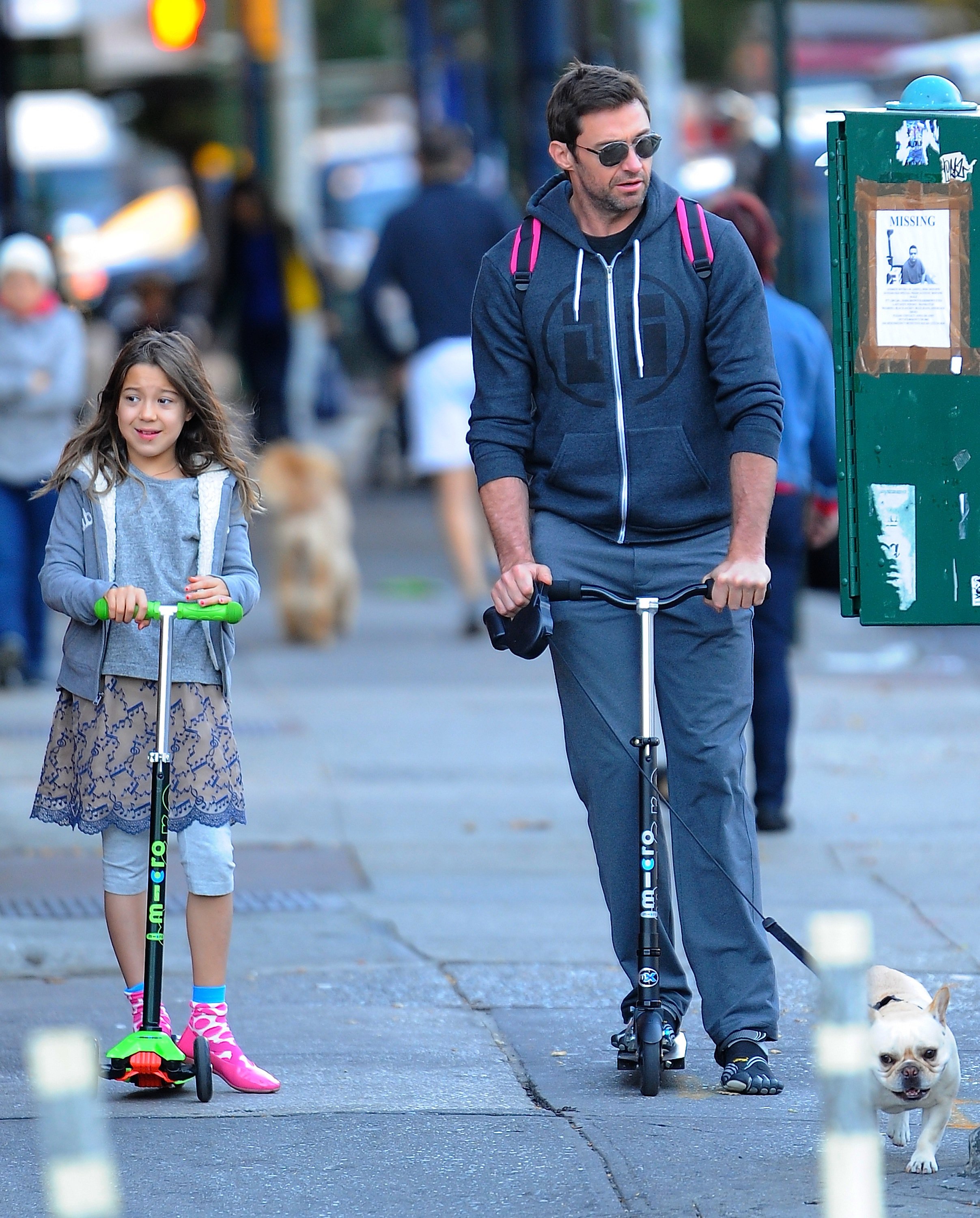 Ava Eliot Jackman and Hugh Jackman riding their scooters in New York on October 18, 2013 | Source: Getty Images