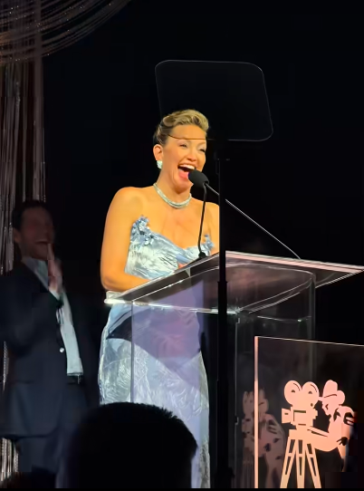 Kate Hudson laughing on stage after she made the joke about Goldie Hawn and Kurt Russell, posted on October 9, 2025. | Source: Facebook/Kate Hudson
