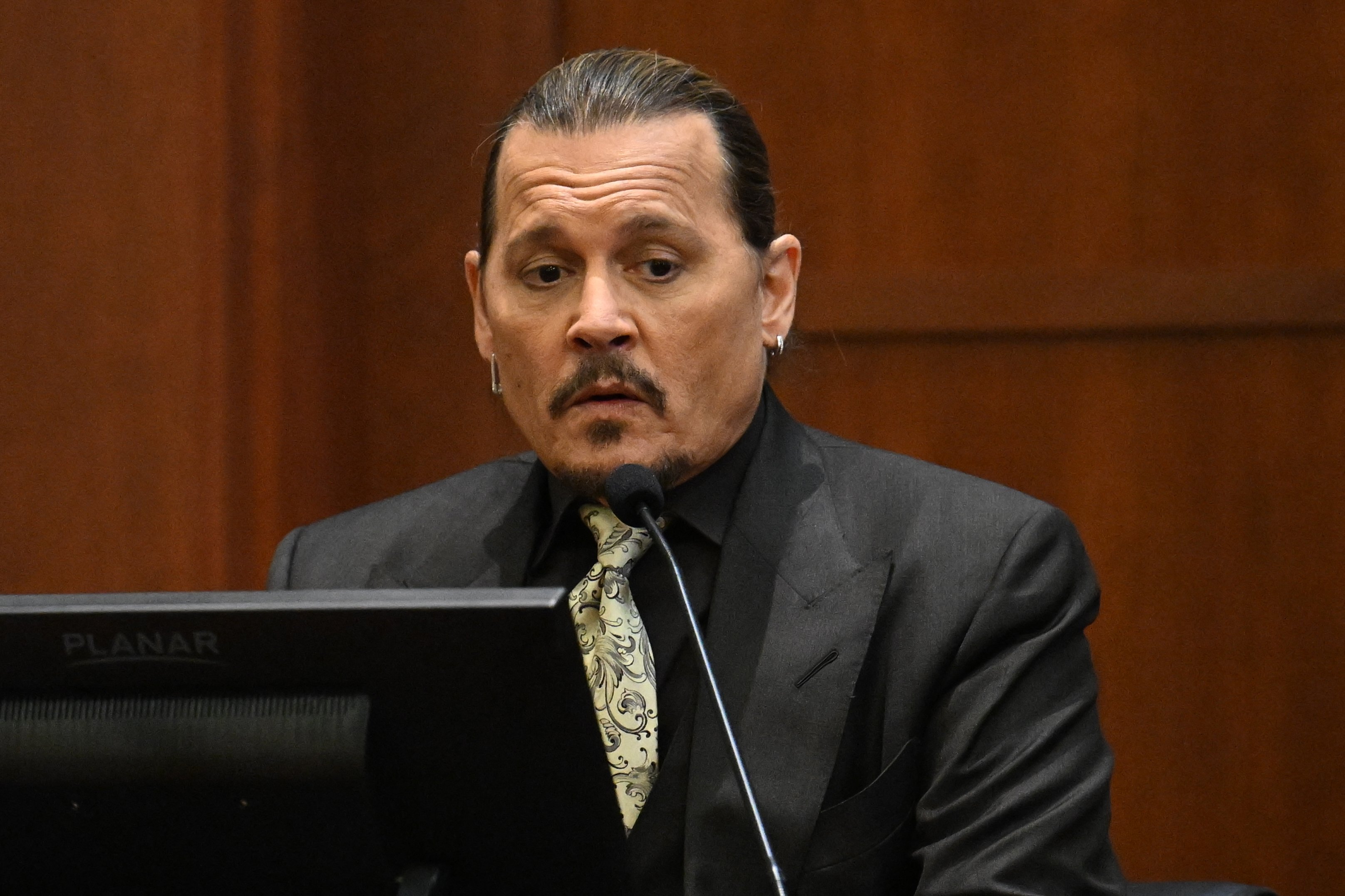 Johnny Depp testifies during his defamation trial in the Fairfax County Circuit Courthouse in Fairfax, Virginia, on April 19, 2022. | Source: Getty Images