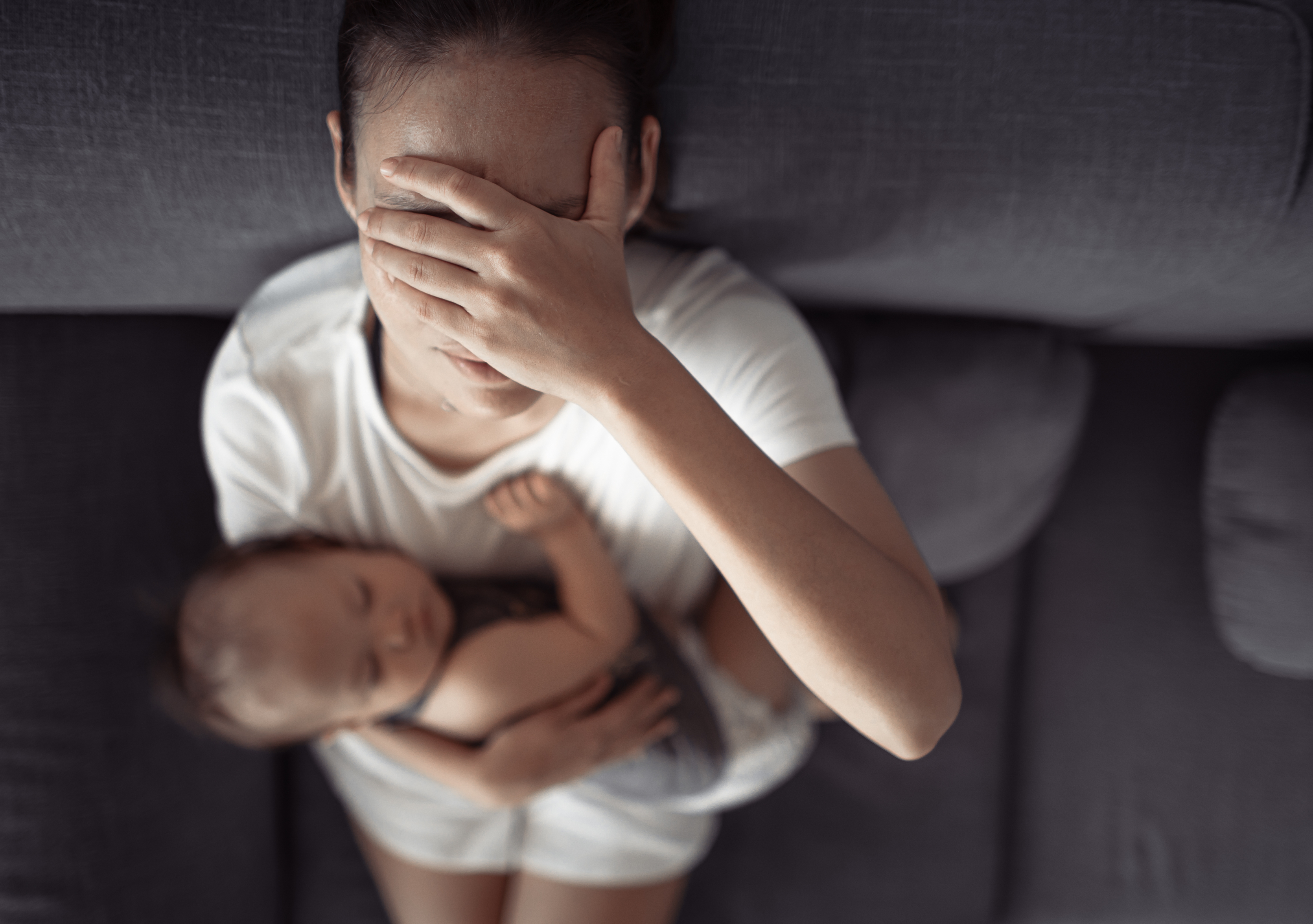 A frustrated woman with a baby | Source: Shutterstock