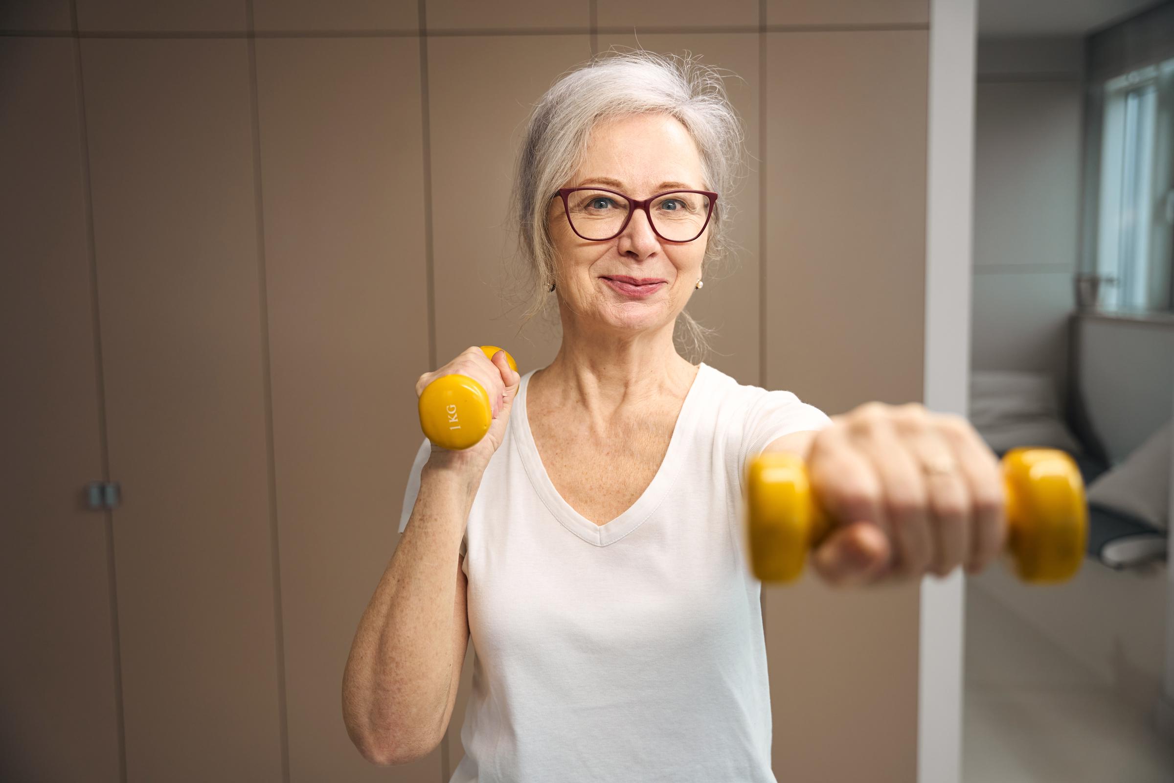 Woman exercising with dumbells | Source: Shutterstock