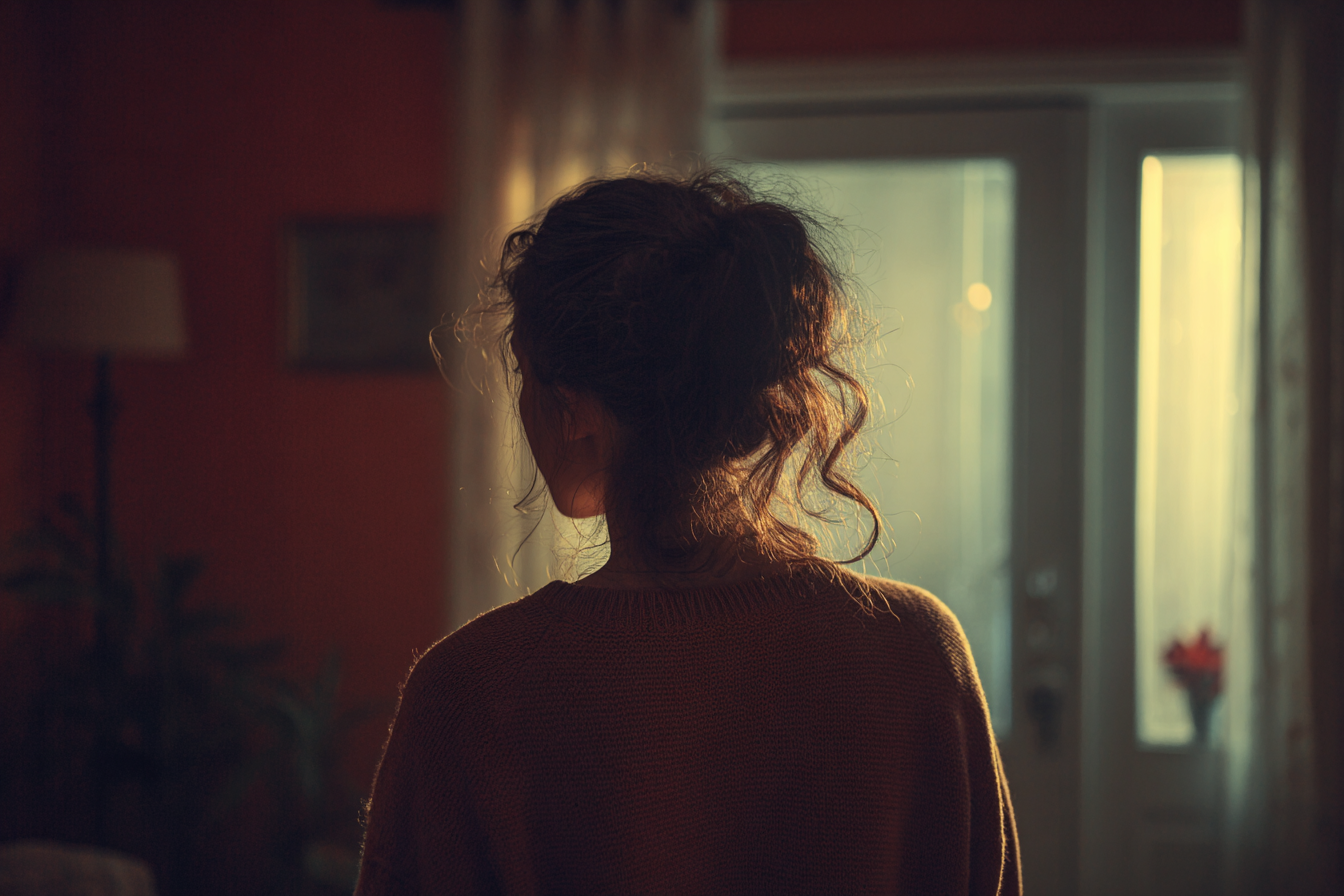 A woman standing in her room | Source: Midjourney