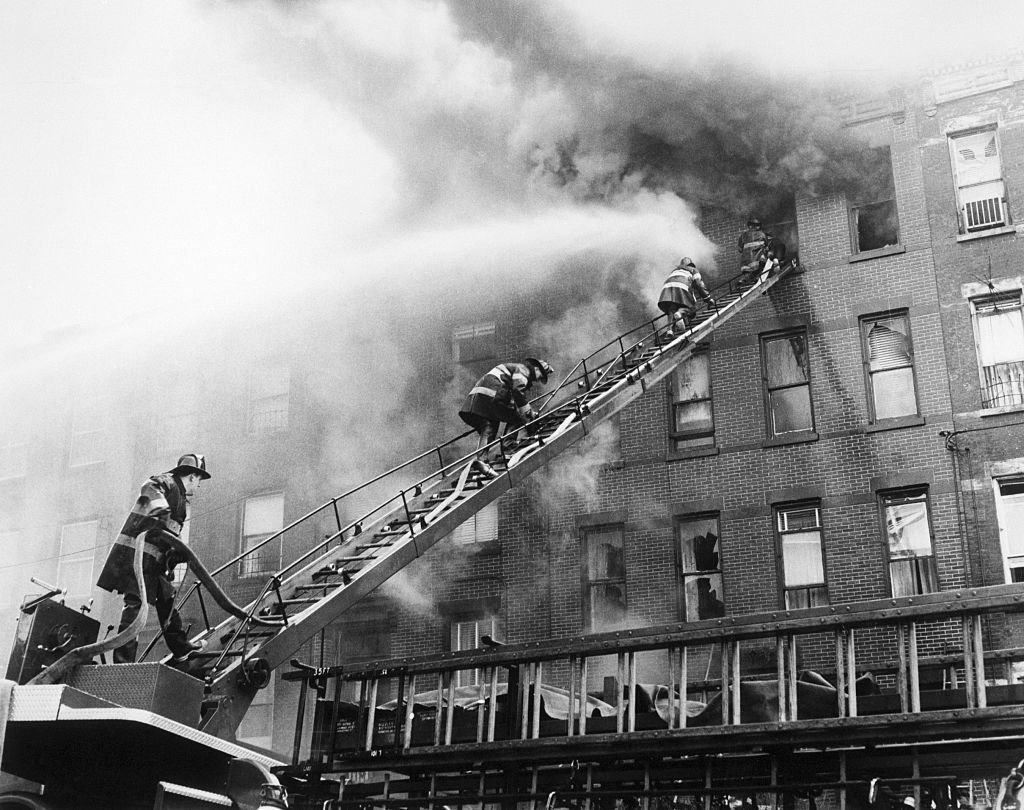 Firefighters rescuing a burnt down house in Brooklyn, new York. | Source: Getty Images