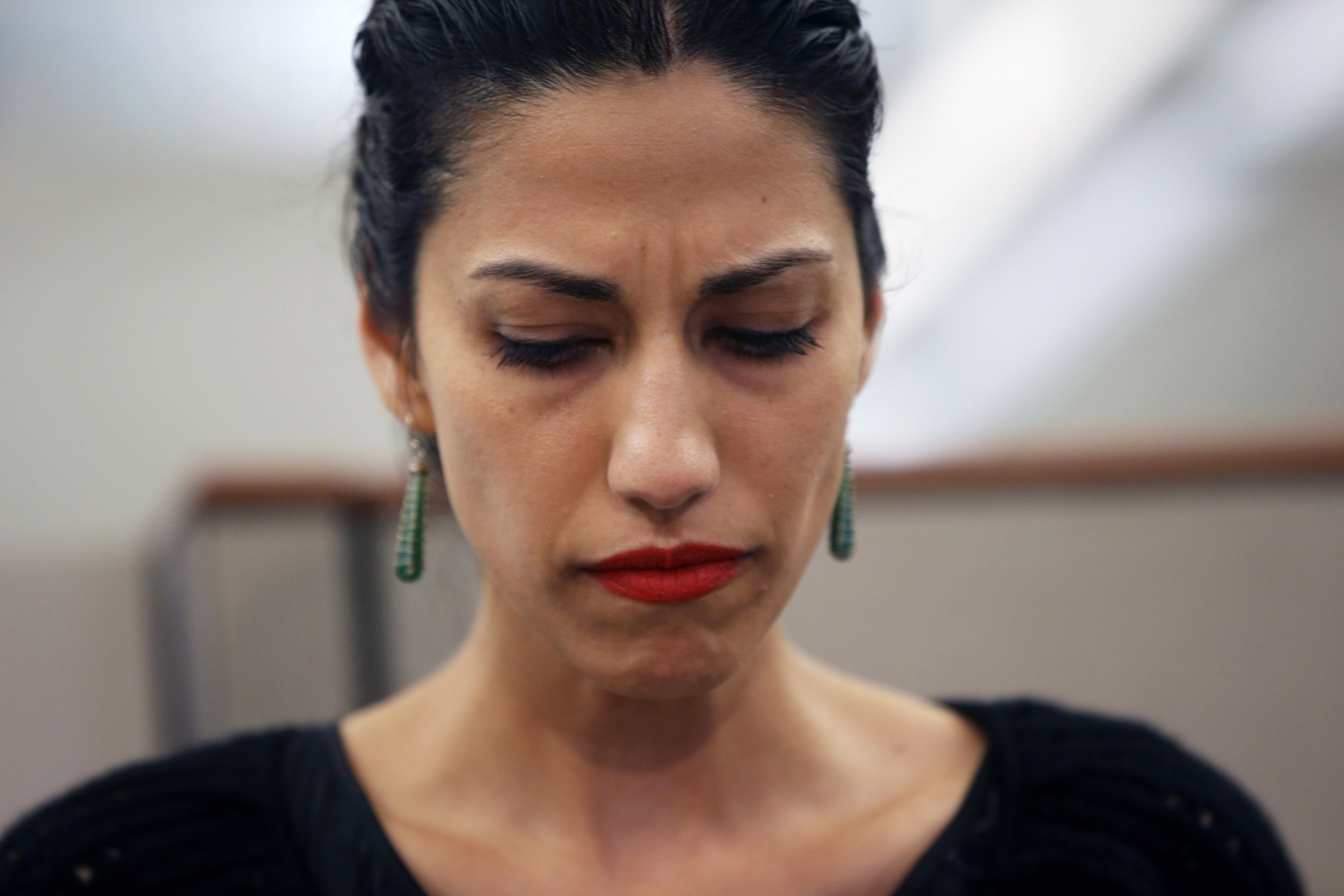  Huma Abedin, wife of Anthony Weiner, a leading candidate for New York City mayor, listens as her husband speaks at a press conference on July 23, 2013 in New York City | Source: Getty Images