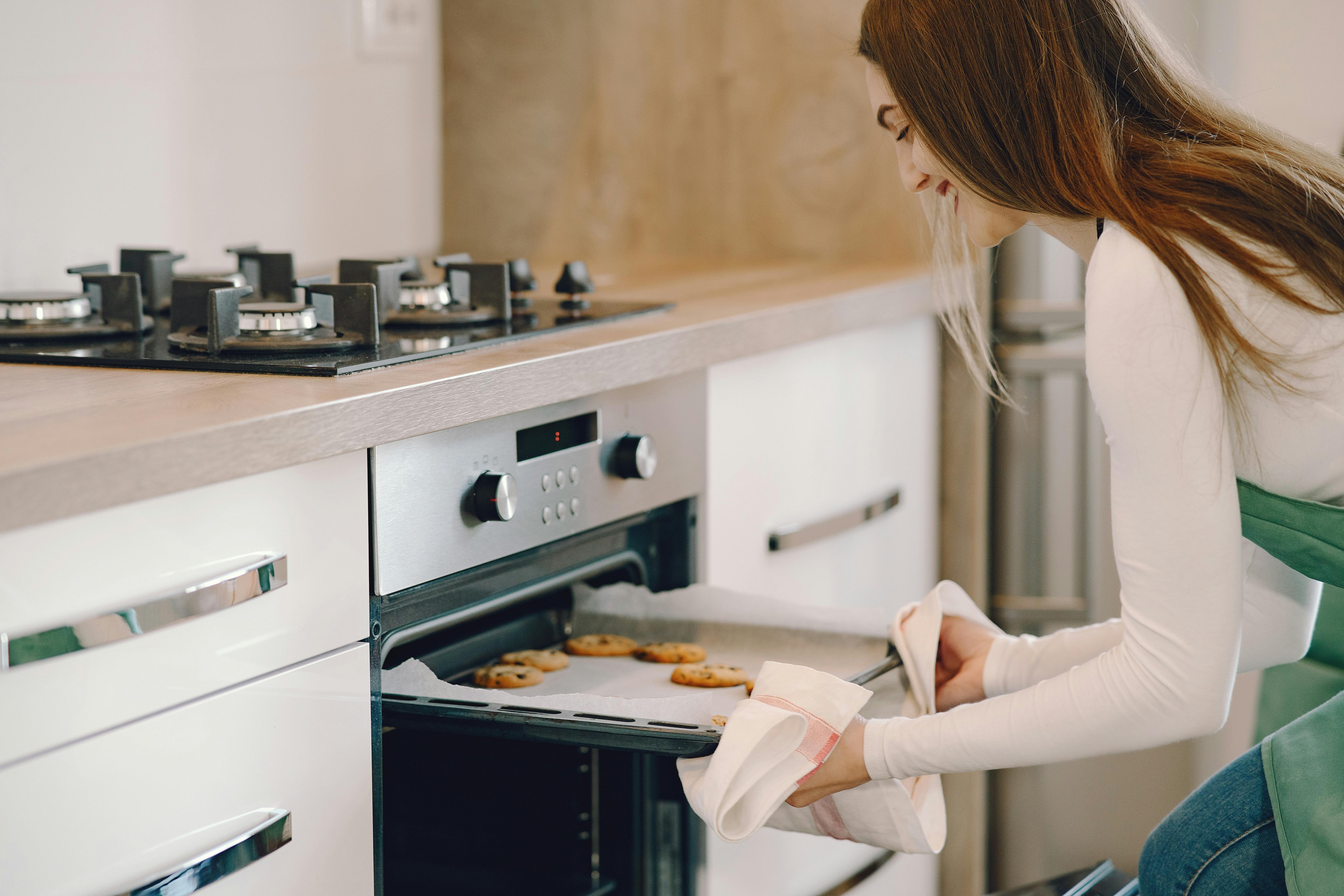 Woman taking out cookies | Source: Pexels