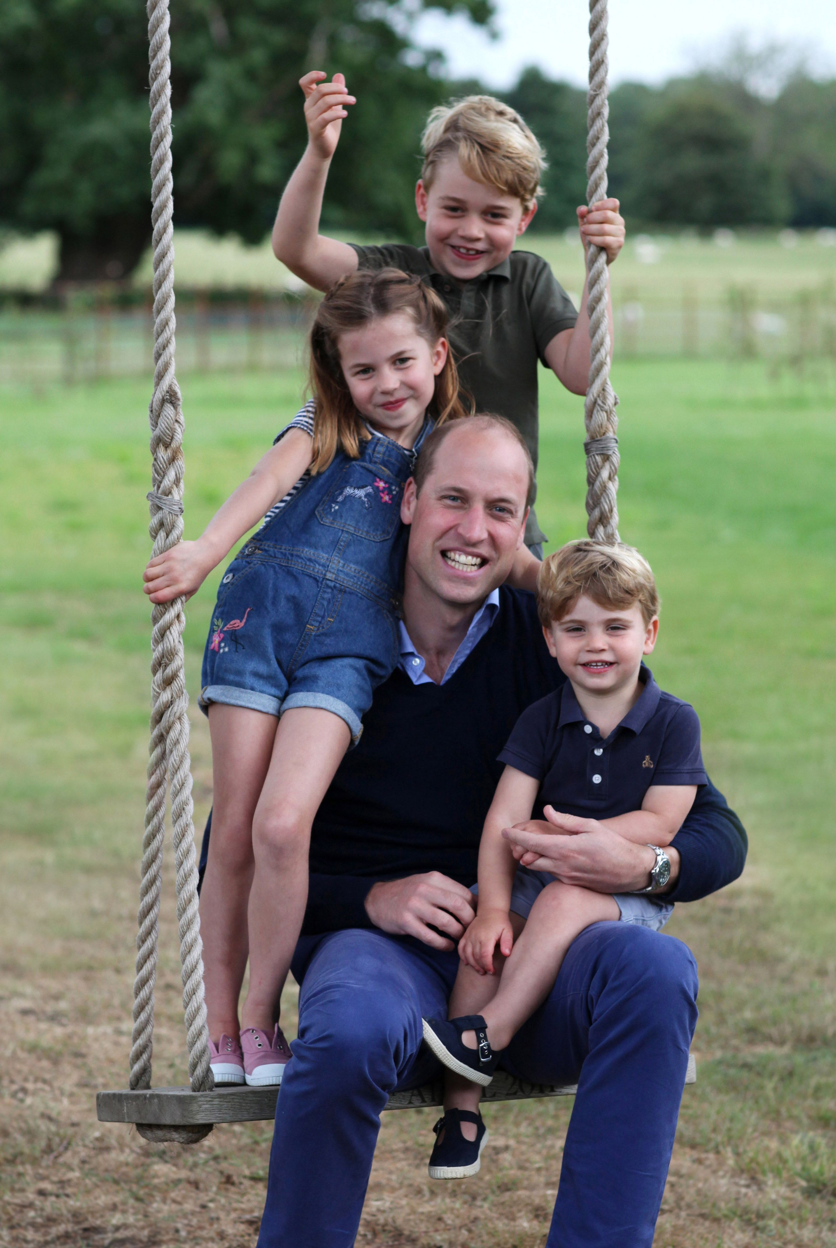 Prince William on a swing with Prince George, Princess Charlotte, and Prince Louis to mark both his birthday and Fathers Day on June 20, 2020, at Kensington Palace | Photo: Duchess Kate/Kensington Palace/Getty Images