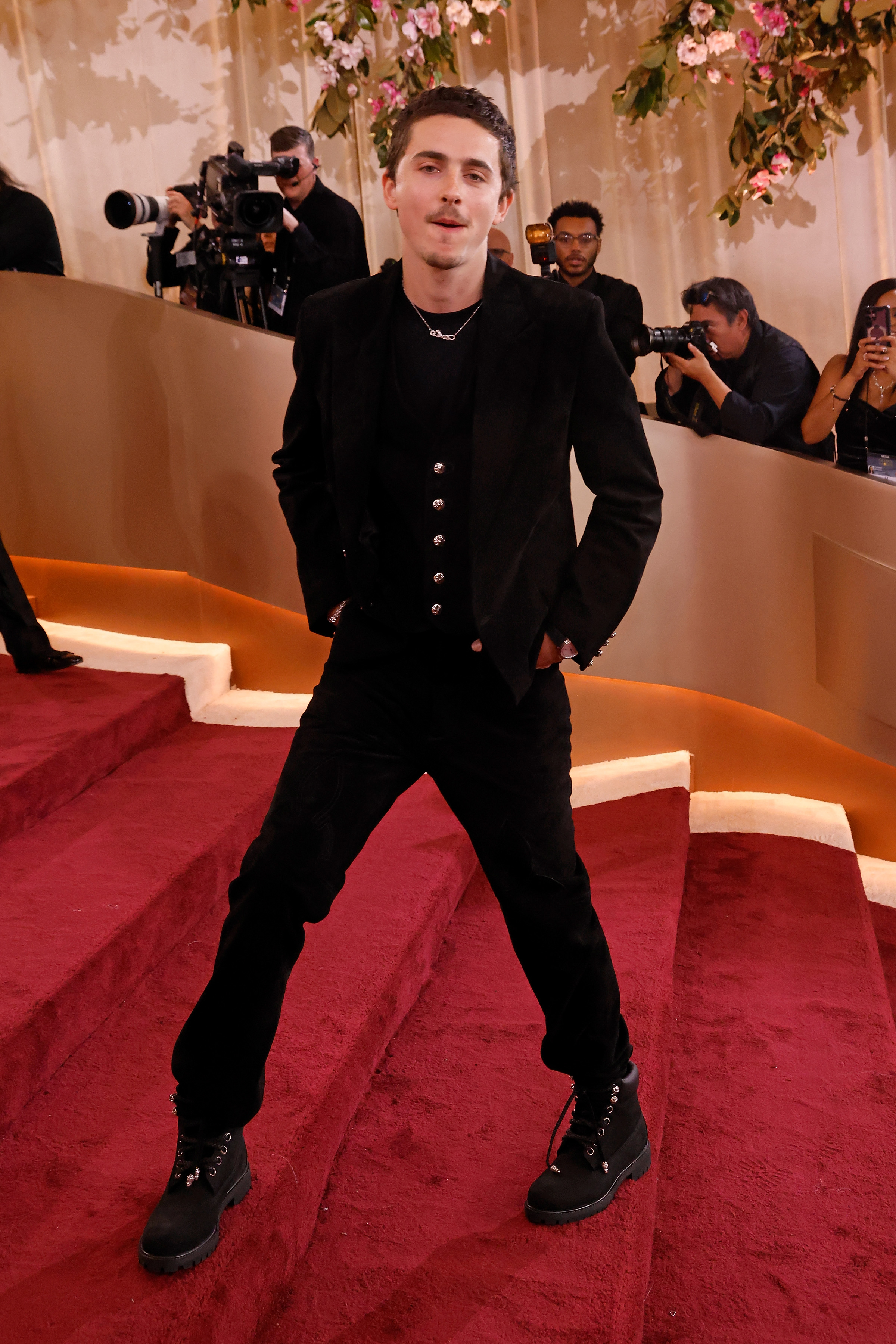 Timothée Chalamet makes a relaxed entrance, pairing a minimalist suit with his signature ease | Source: Getty Images