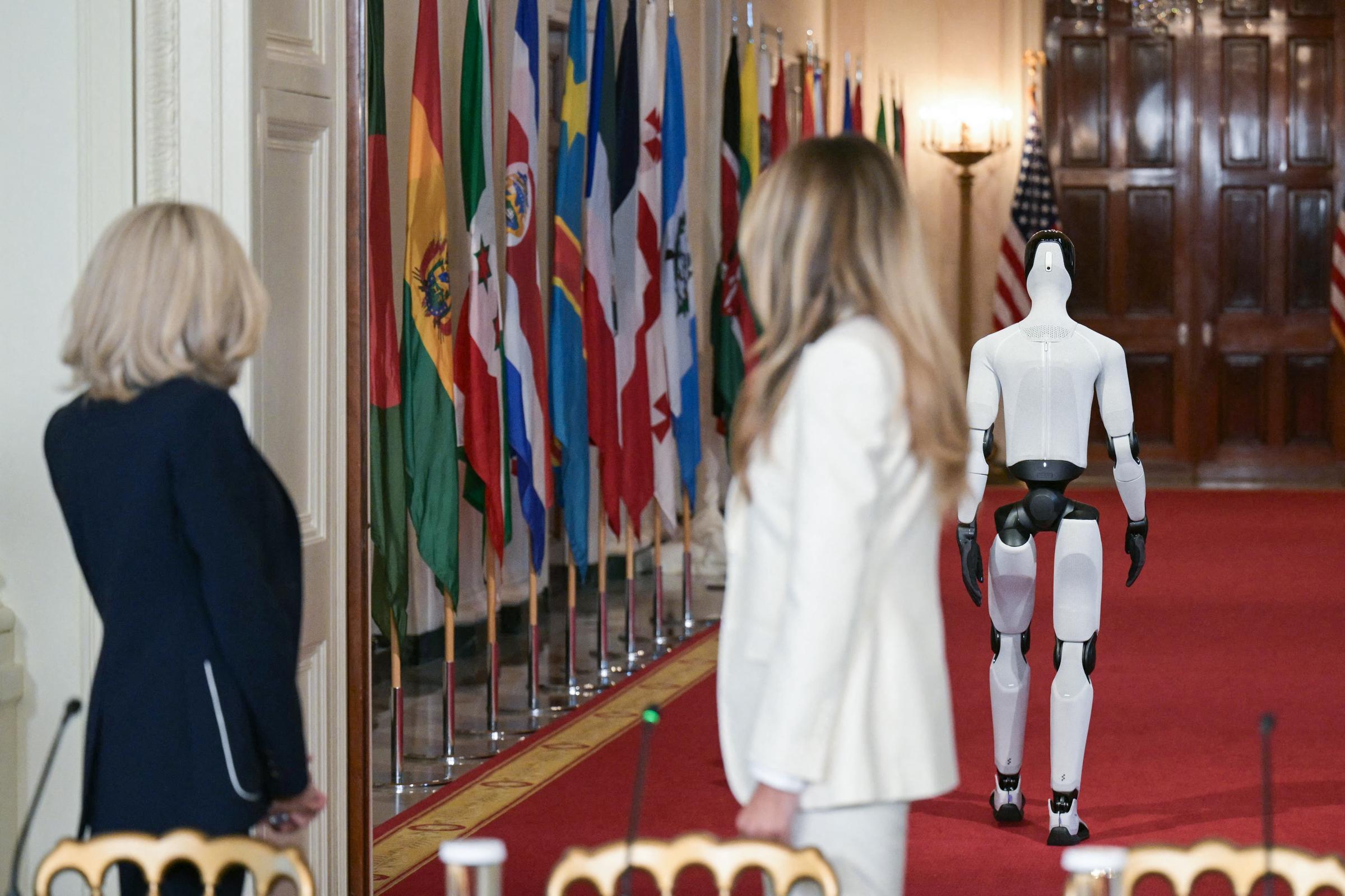 Brigitte Macron and Melania Trump watch the humanoid robot depart at the Global Coalition Summit at the White House on March 25, 2026. | Source: Getty Images