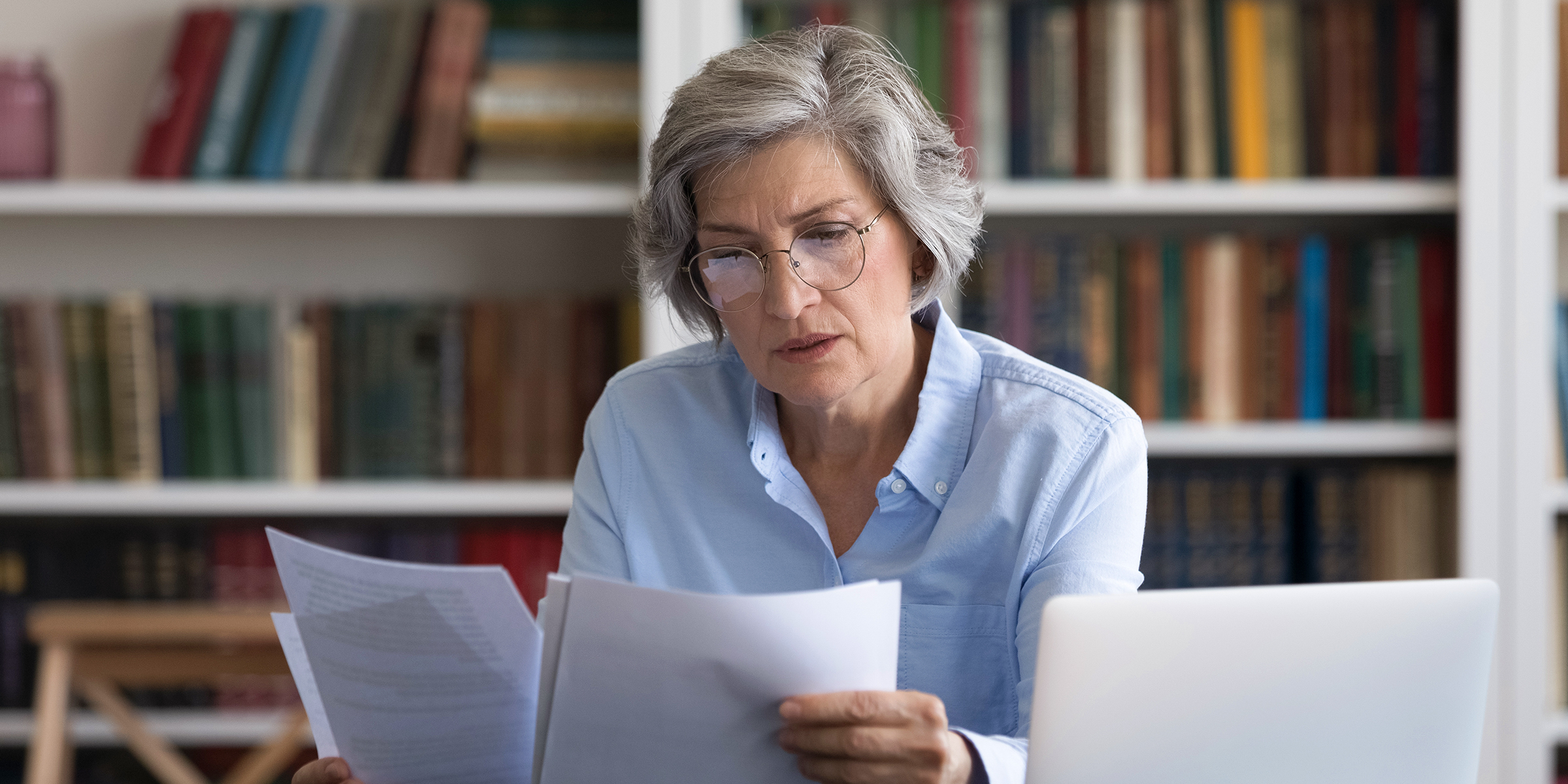 An elderly lady reading documents | Source: Shutterstock