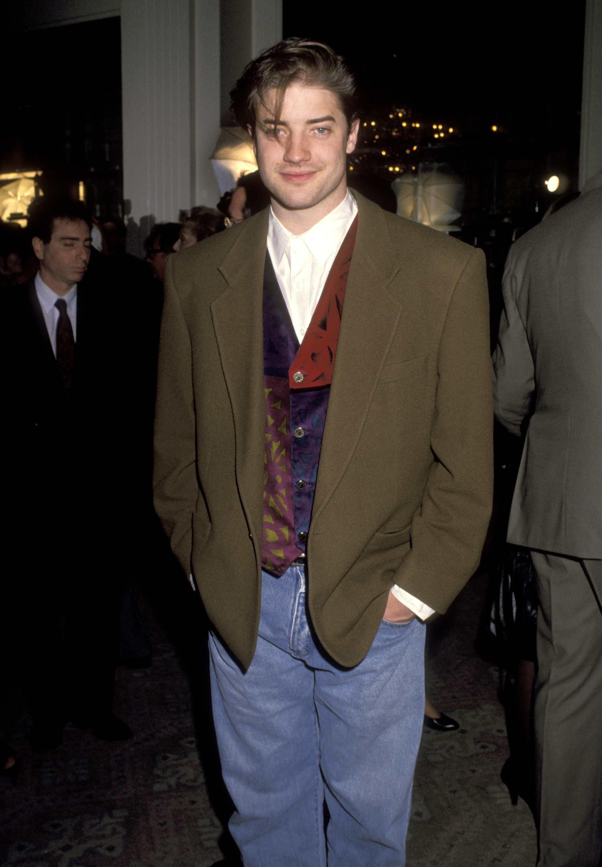 Brendan Fraser looks youthful in an oversized olive blazer, patterned vest, white shirt, and jeans at the 52nd Annual Golden Apple Awards at the Beverly Hilton Hotel in Beverly Hills, California.