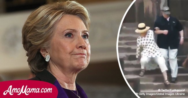 Hillary Clinton slips on the stairs several times, can't move without the help of two men