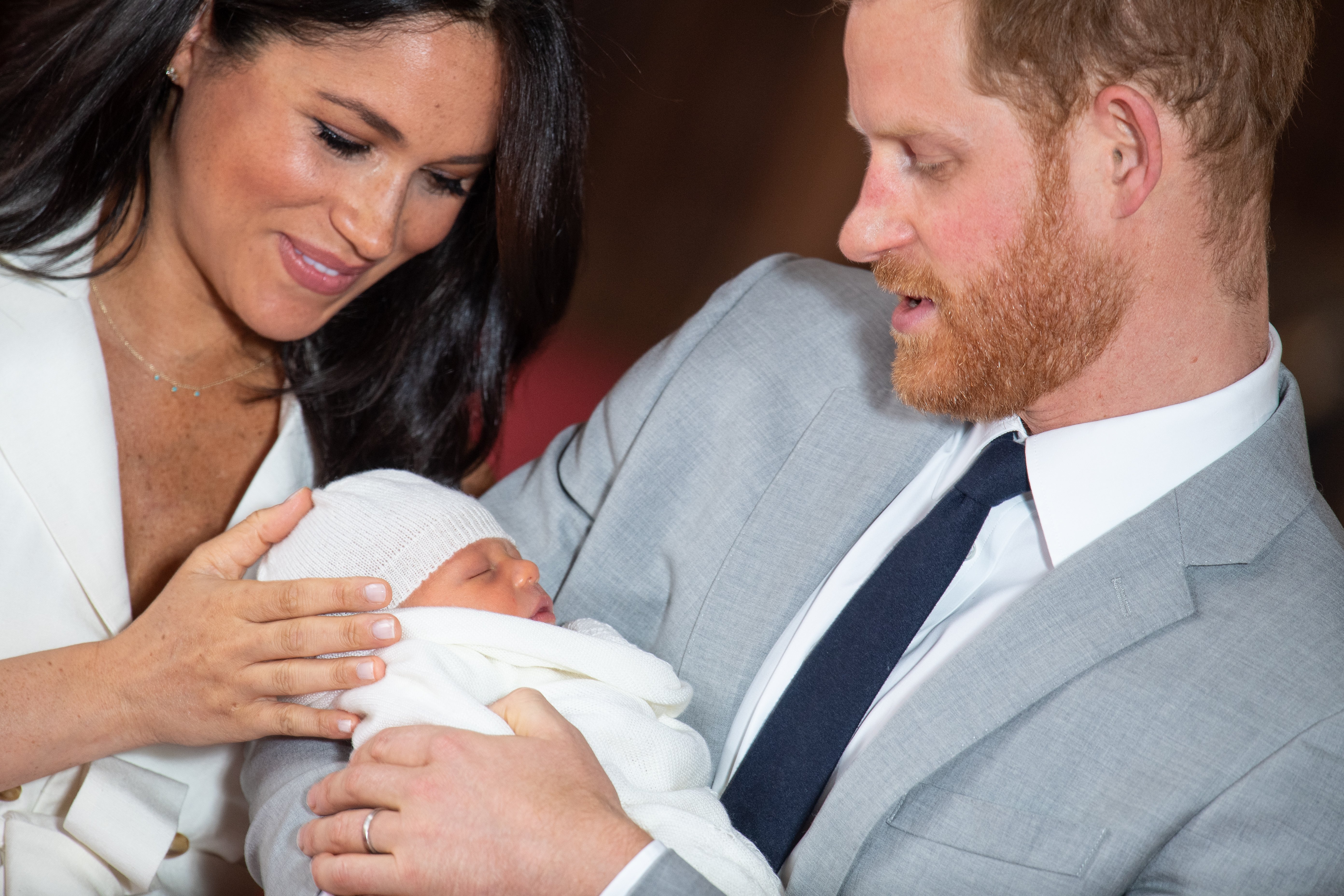 Prince Harry, Duke of Sussex and Meghan, Duchess of Sussex, pose with their newborn son Archie Harrison Mountbatten-Windsor during a photocall in St George's Hall at Windsor Castle on May 8, 2019 in Windsor, England. | Source: Getty Images