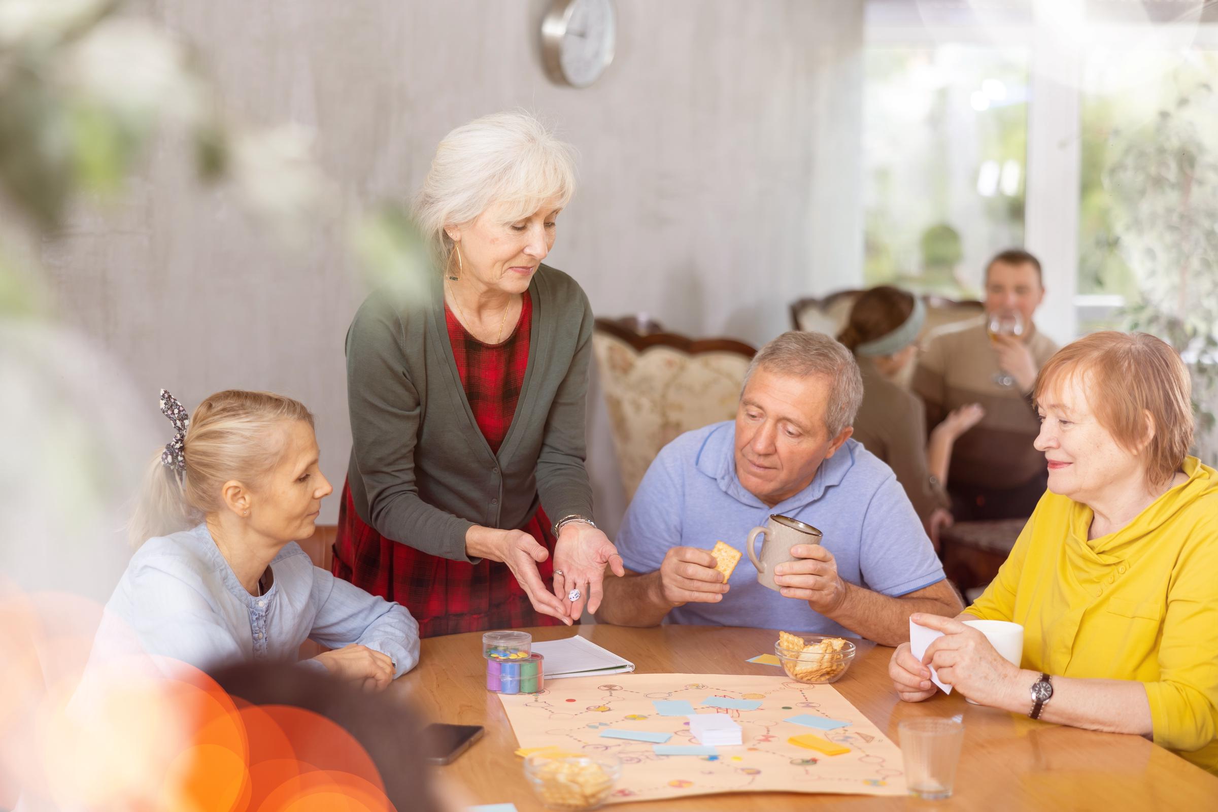 A group of older adults playing a board game | Source: Shutterstock