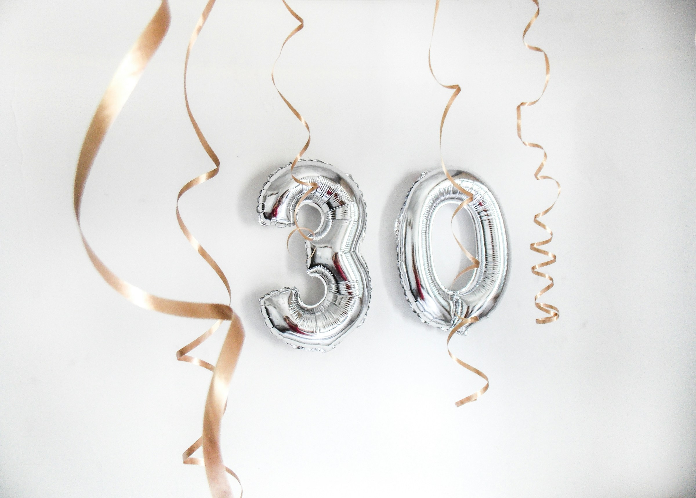Silver birthday balloons | Source: Unsplash