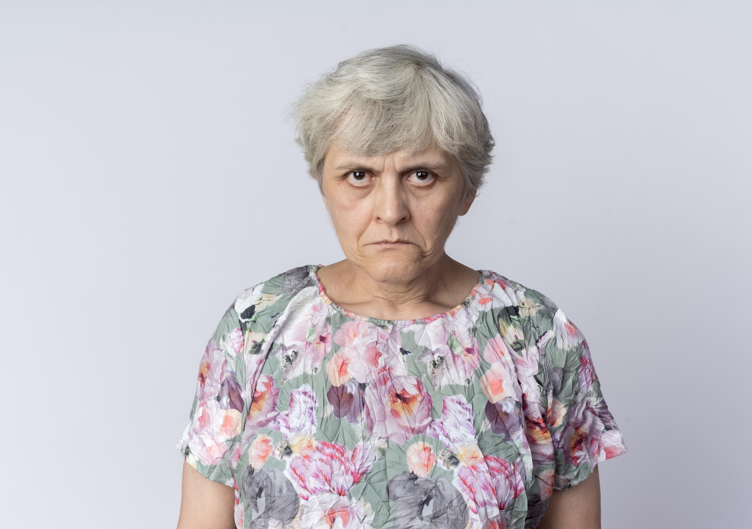 A frustrated older woman staring daggers | Source: Freepik