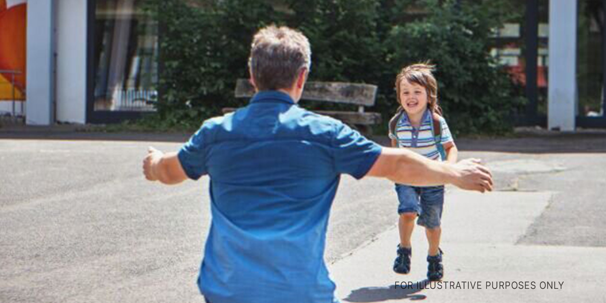 Boy running into father's arms. | Source: Shutterstock