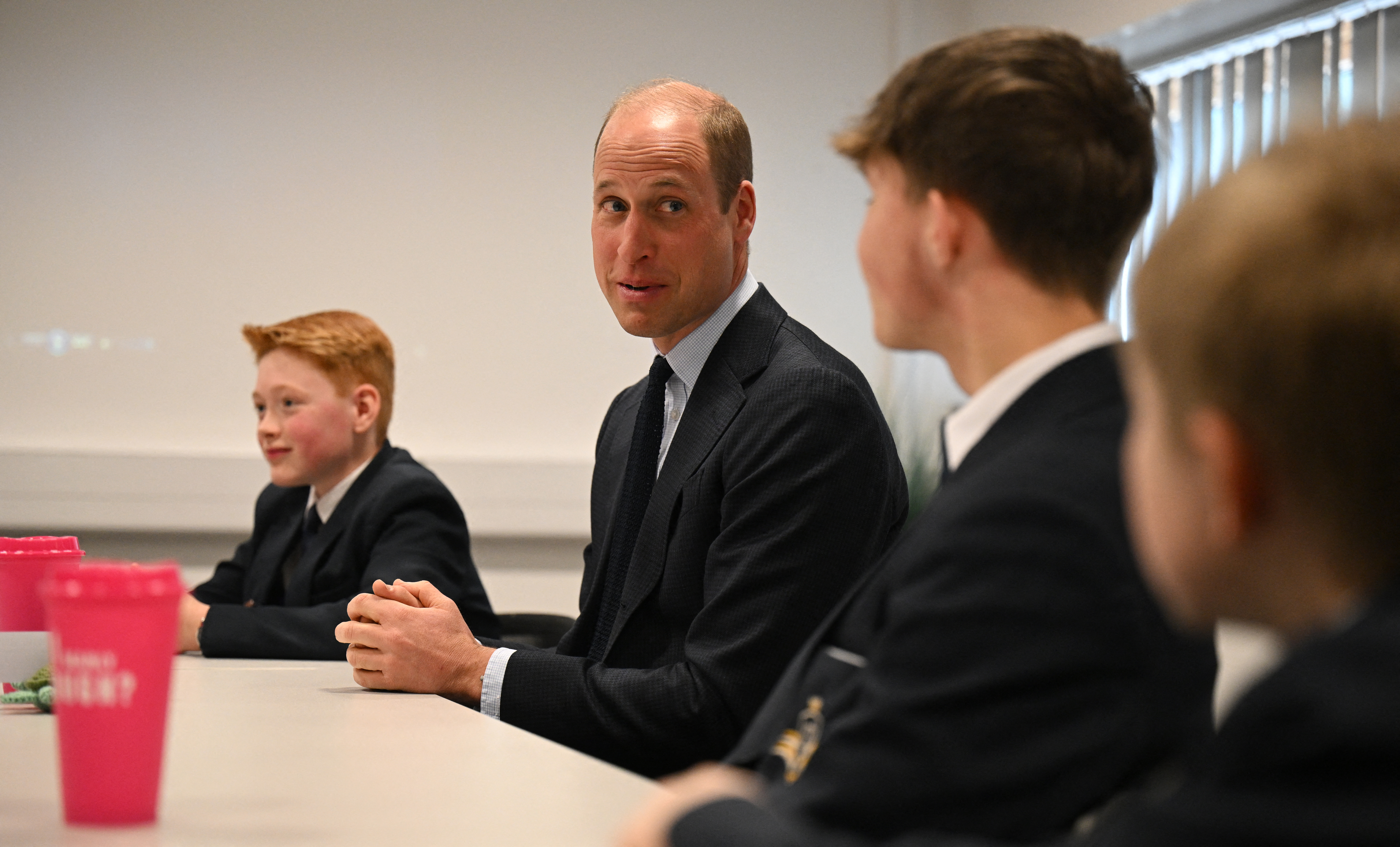 Prince William talks with students of the Matrix Project, including Freddie Hadley, during a visit to St. Michael's Church of England High School in Rowley Regis, on April 25, 2024 in Birmingham, England. | Source: Getty Images