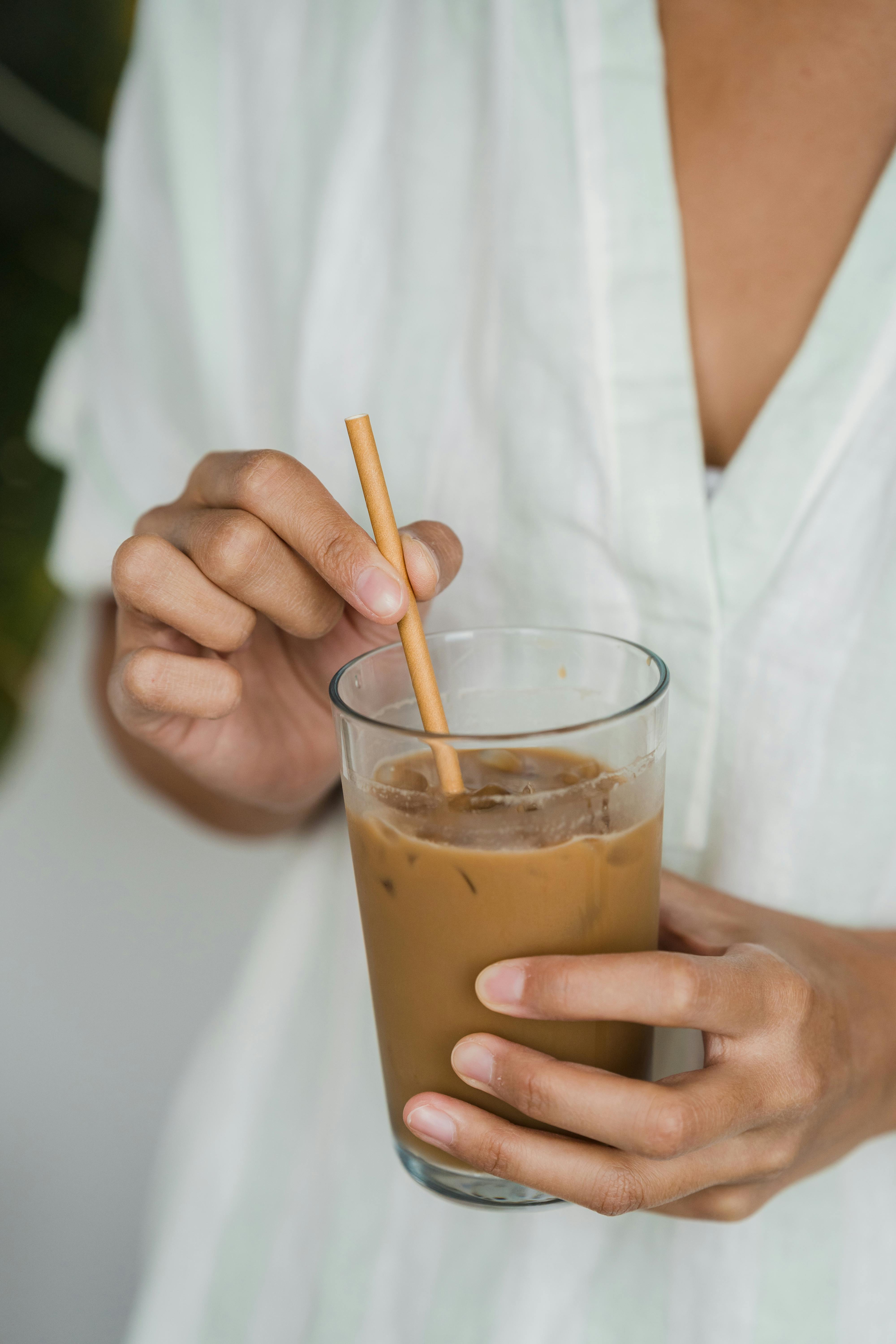 A woman drinking iced coffee | Source: Pexels