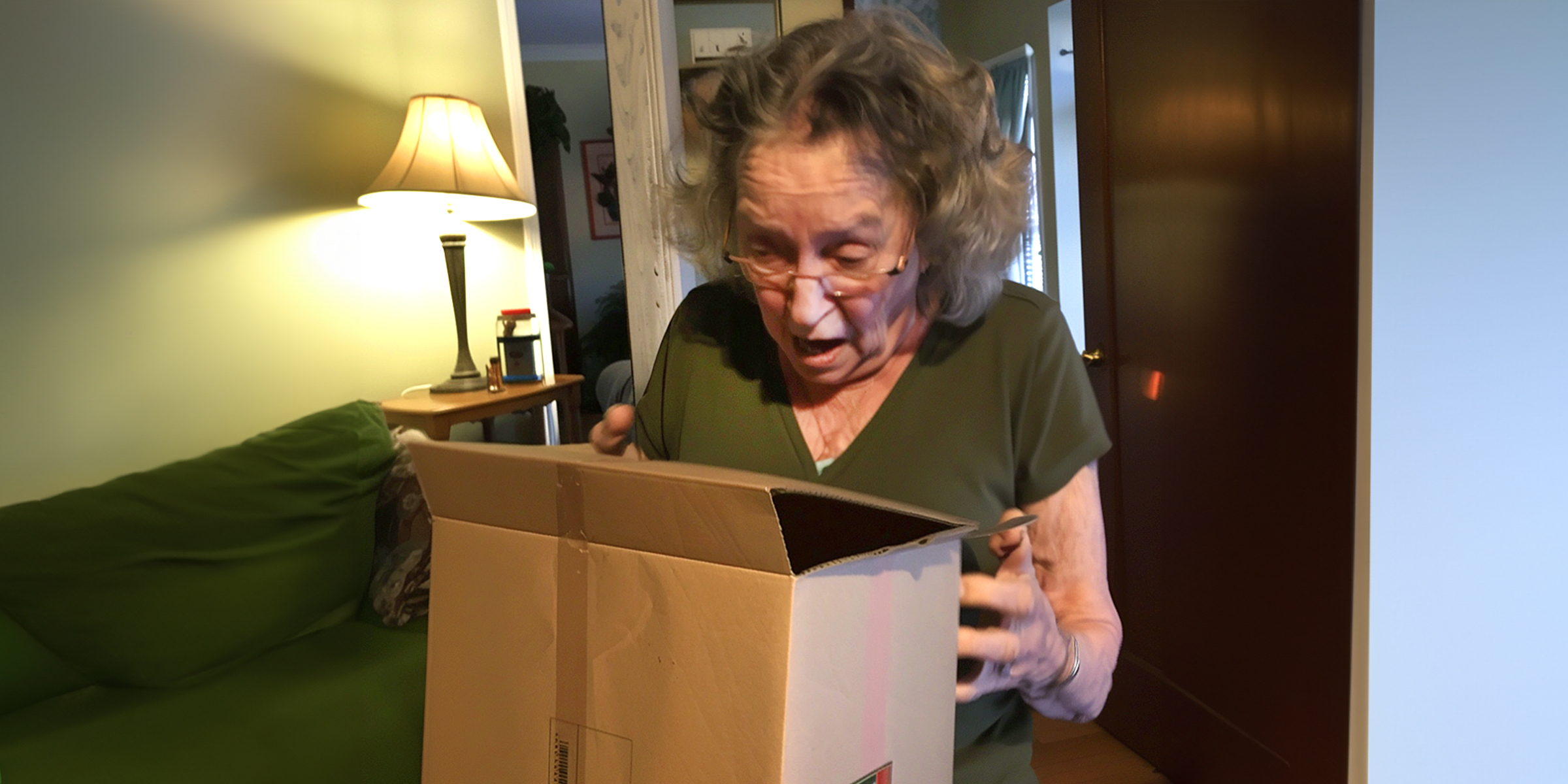 A shocked woman looking inside a box | Source: Amomama