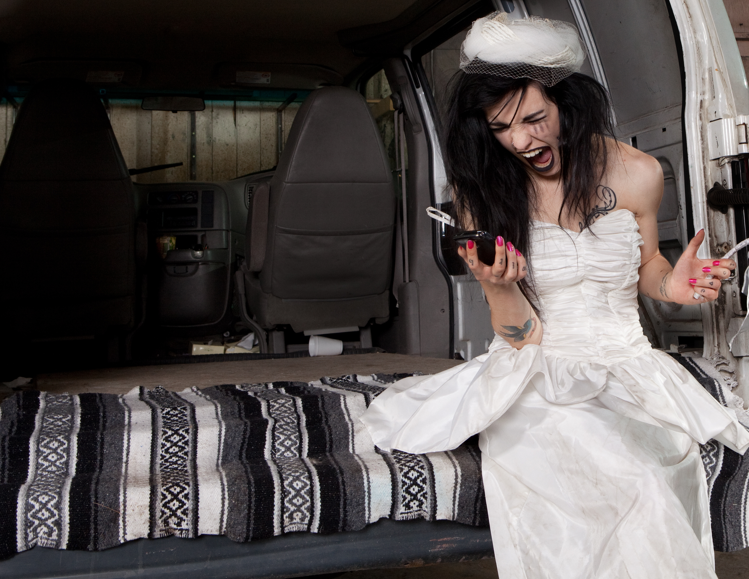 A bride screaming at her phone | Source: Shutterstock