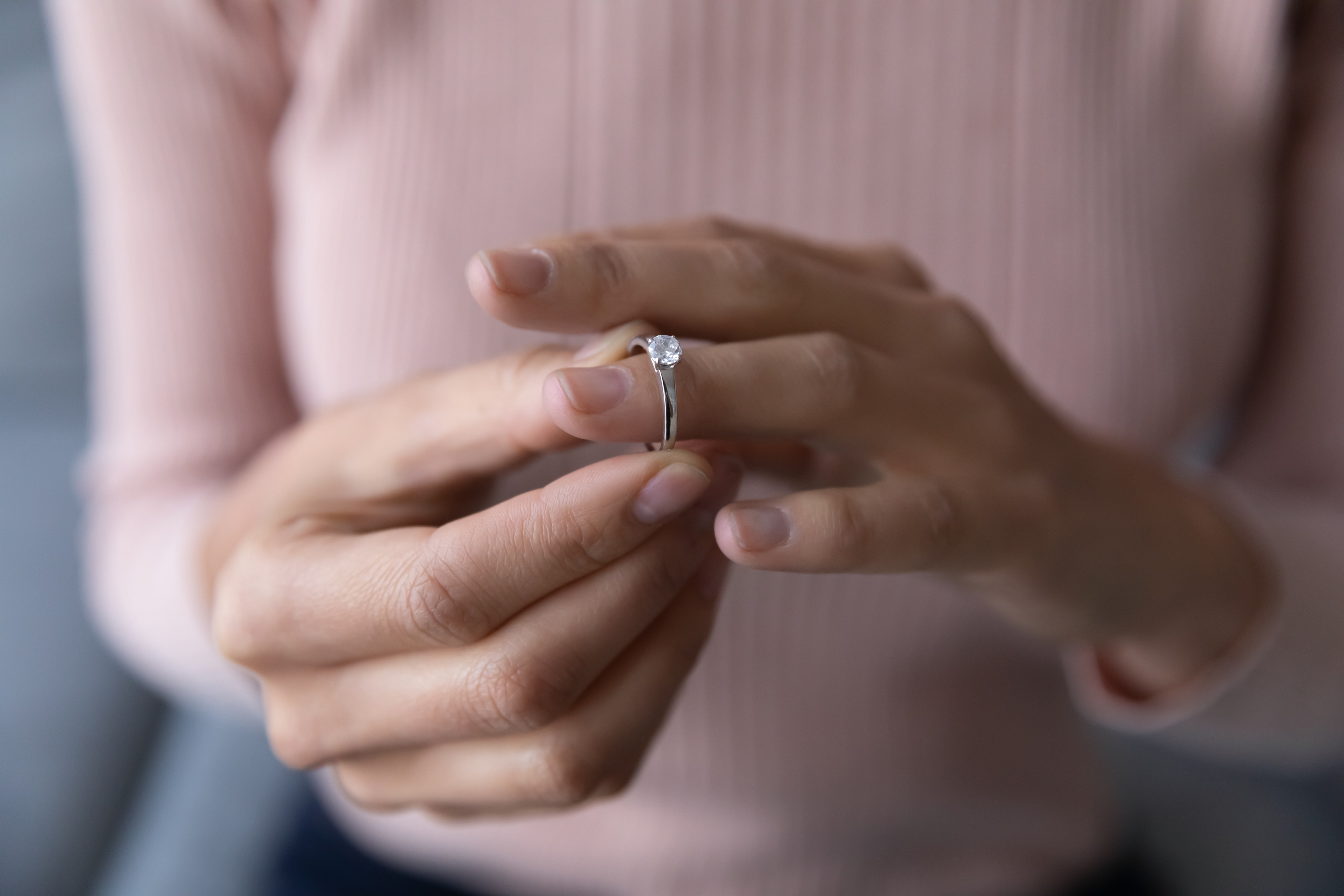 Woman taking off a diamond ring. | Source: Shutterstock