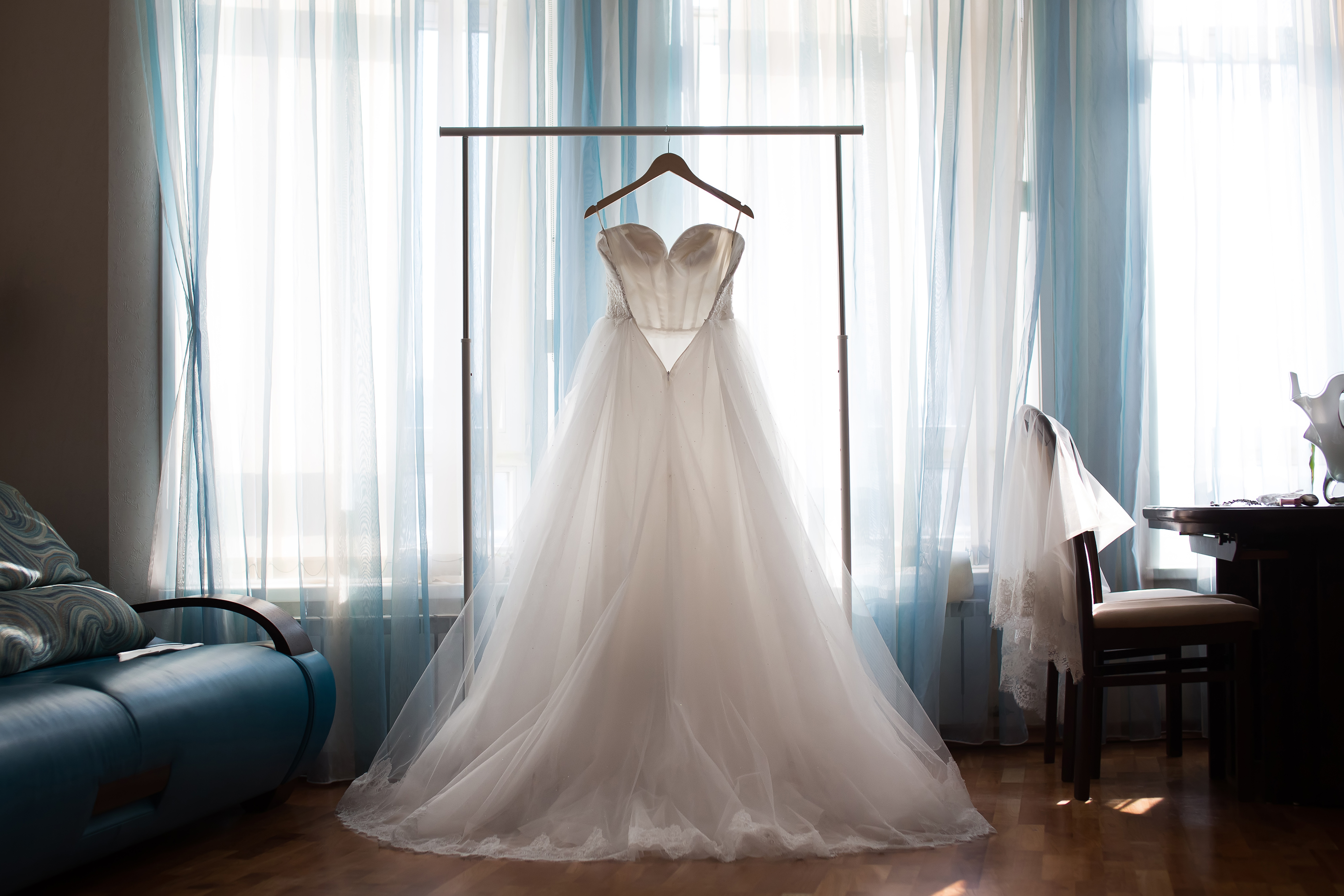 A white wedding dress on a hanger | Source: Shutterstock